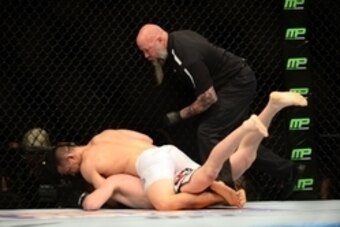 Feb 14, 2015; Broomfield, CO, USA; James Moontasri (top) performs a rear-naked choke on Cody Pfister (below) during UFC Fight Night at the 1stBANK Center. Mandatory Credit: Ron Chenoy-USA TODAY Sports