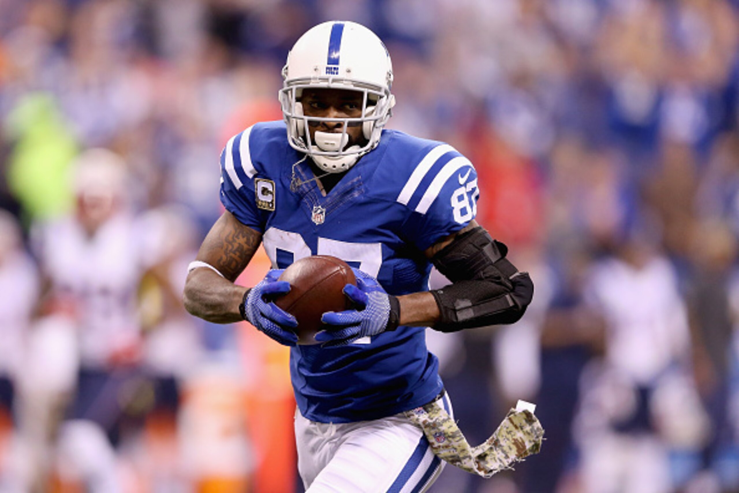 INDIANAPOLIS, IN - NOVEMBER 16:  Reggie Wayne #87 of the Indianapolis Colts runs with the ball against the New England Patriots during the first quarter of the game at Lucas Oil Stadium on November 16, 2014 in Indianapolis, Indiana.  (Photo by Andy Lyons/
