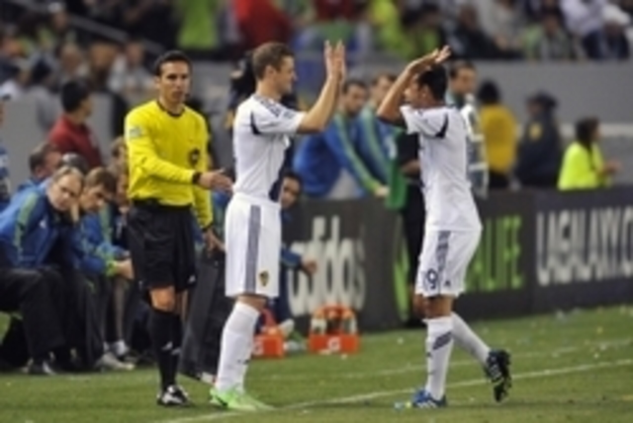 May 26, 2013; Carson, CA, USA; Los Angeles Galaxy midfielder Robbie Rogers (14) greets midfielder Juninho (19) before coming onto the field against the Seattle Sounders during the second half at Home Depot Center. Mandatory Credit: Gary A. Vasquez-USA TOD