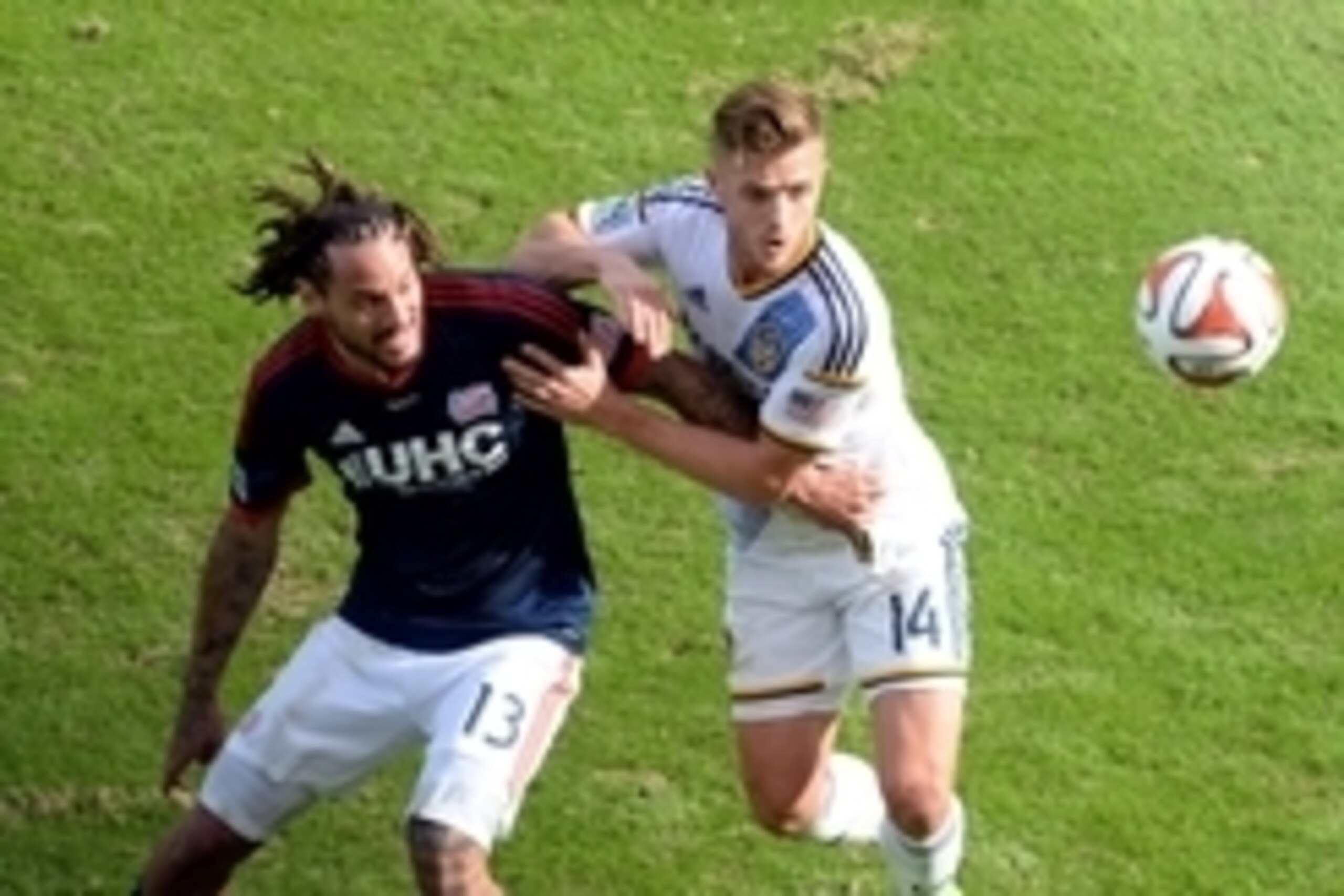 Dec 7, 2014; Los Angeles, CA, USA; Los Angeles Galaxy midfielder Robbie Rogers (14) battles for the ball with New England Revolution midfielder Jermaine Jones (13) in the second half during the 2014 MLS Cup final at Stubhub Center. Mandatory Credit: Jayne