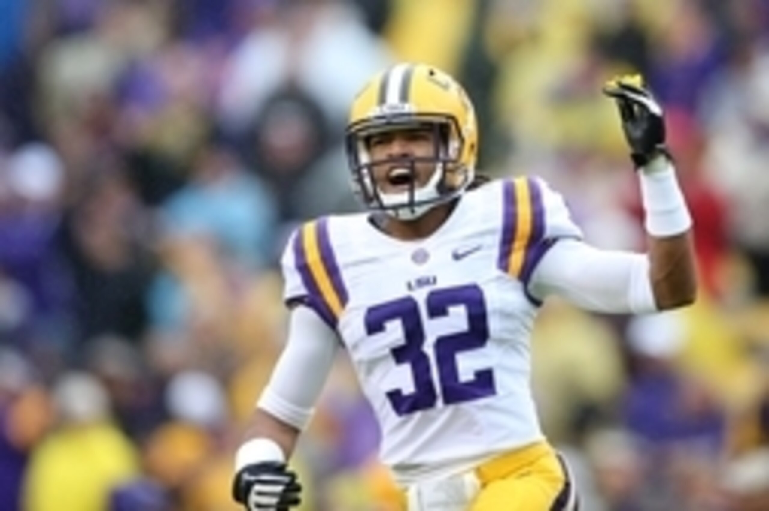 Nov 23, 2013; Baton Rouge, LA, USA; LSU Tigers cornerback Jalen Collins (32) raises his arm to the crowd prior to kickoff against the Texas A&M Aggies at Tiger Stadium. LSU defeated Texas A&M 34-10. Mandatory Credit: Crystal LoGiudice-USA TODAY Sports