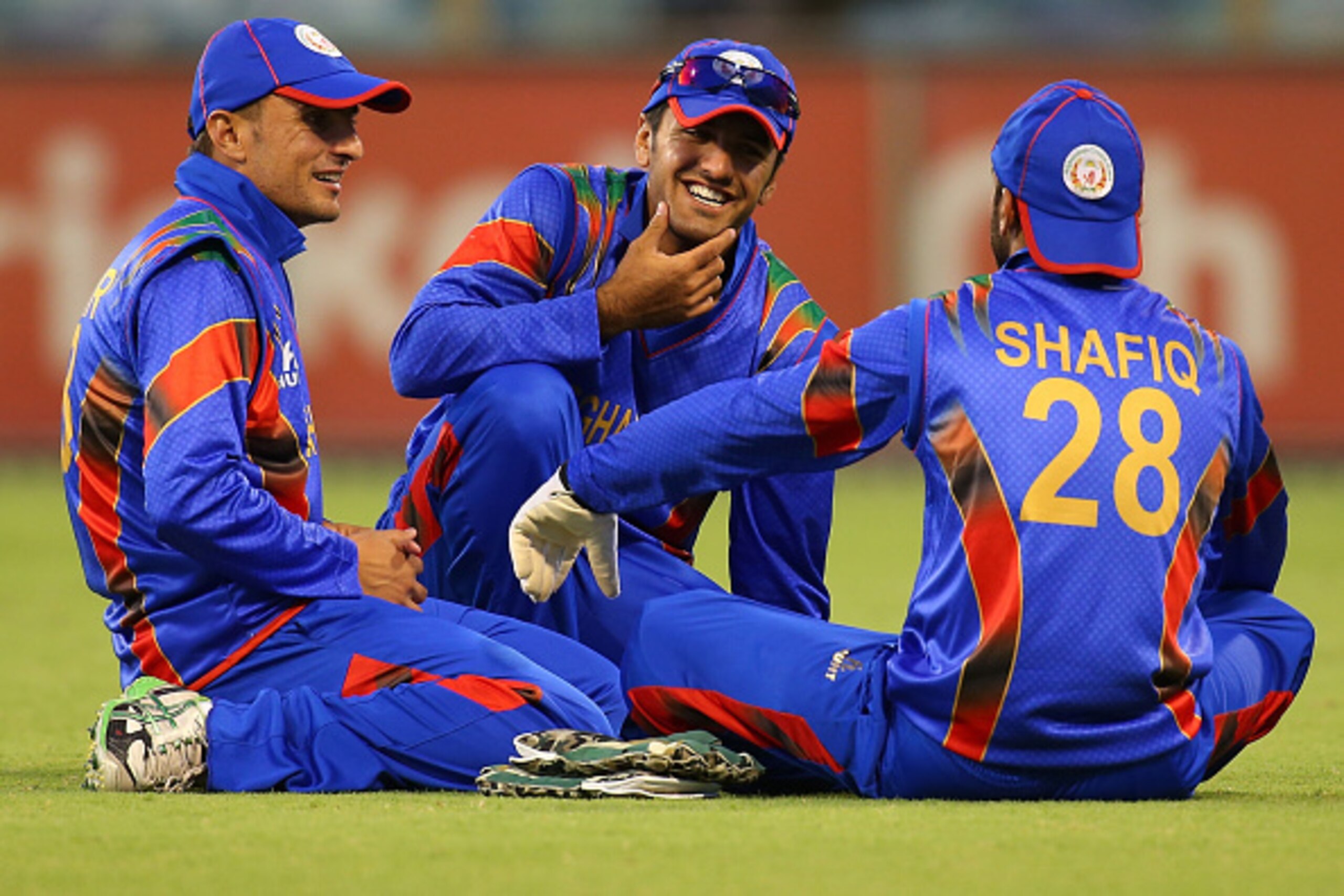 PERTH, AUSTRALIA - SEPTEMBER 22:  Nasir Jamal, Najibullah Zadran and Shafiqullah Shafaq of Afghanistan chat before the resumption of play during the One Day tour match between the Western Australia XI and Afghanistan at the WACA on September 22, 2014 in P