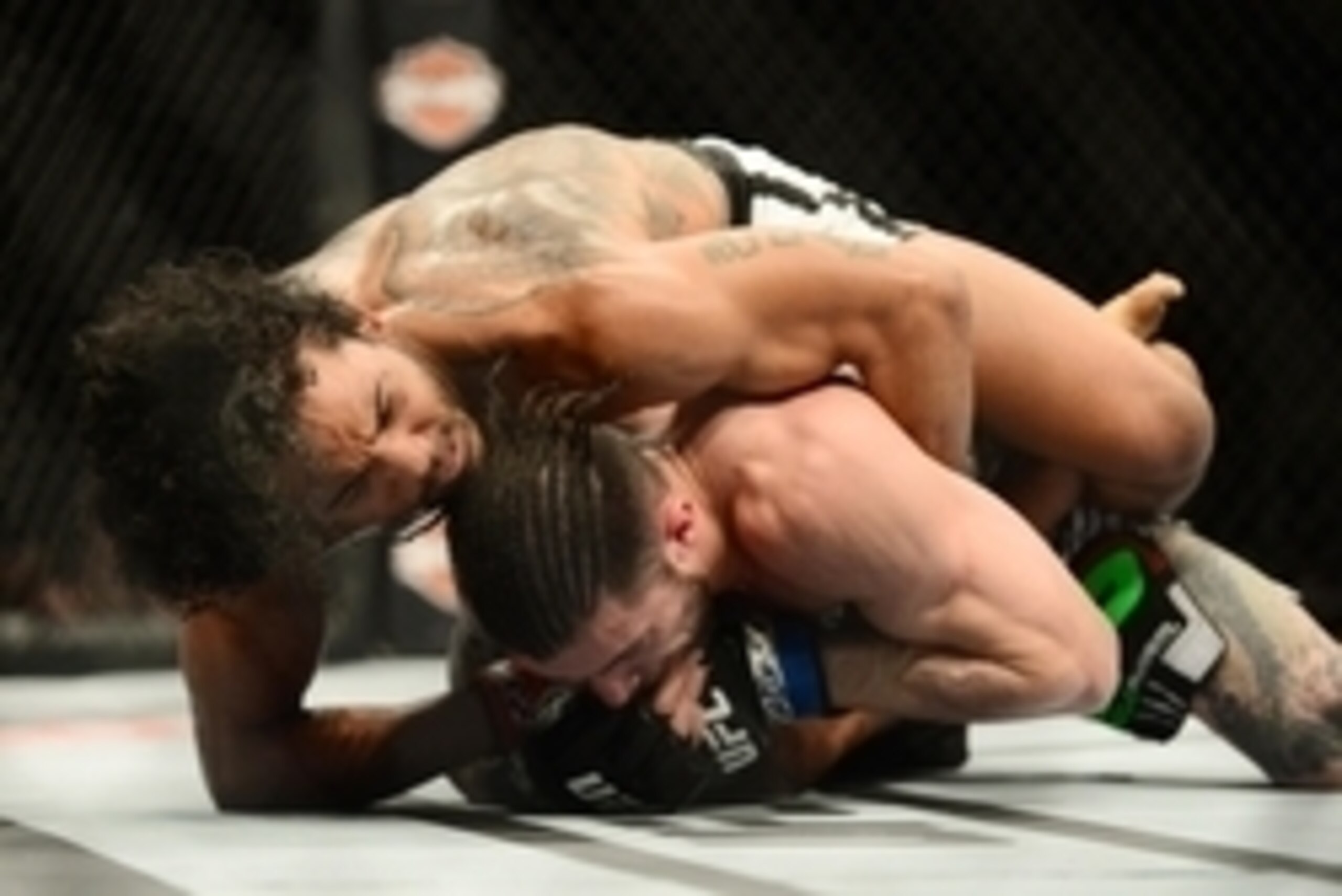 Feb 14, 2015; Broomfield, CO, USA; Brandon Thatch (blue) and Benson Henderson (red) compete in the welterweight bout at the UFC Fight Night at the 1stBANK Center. Mandatory Credit: Ron Chenoy-USA TODAY Sports