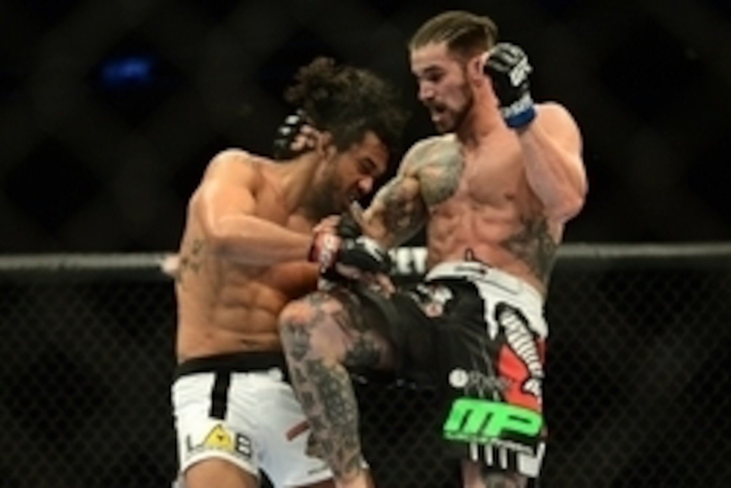 Feb 14, 2015; Broomfield, CO, USA; Brandon Thatch (blue) and Benson Henderson (red) compete in the welterweight bout at the UFC Fight Night at the 1stBANK Center. Mandatory Credit: Ron Chenoy-USA TODAY Sports