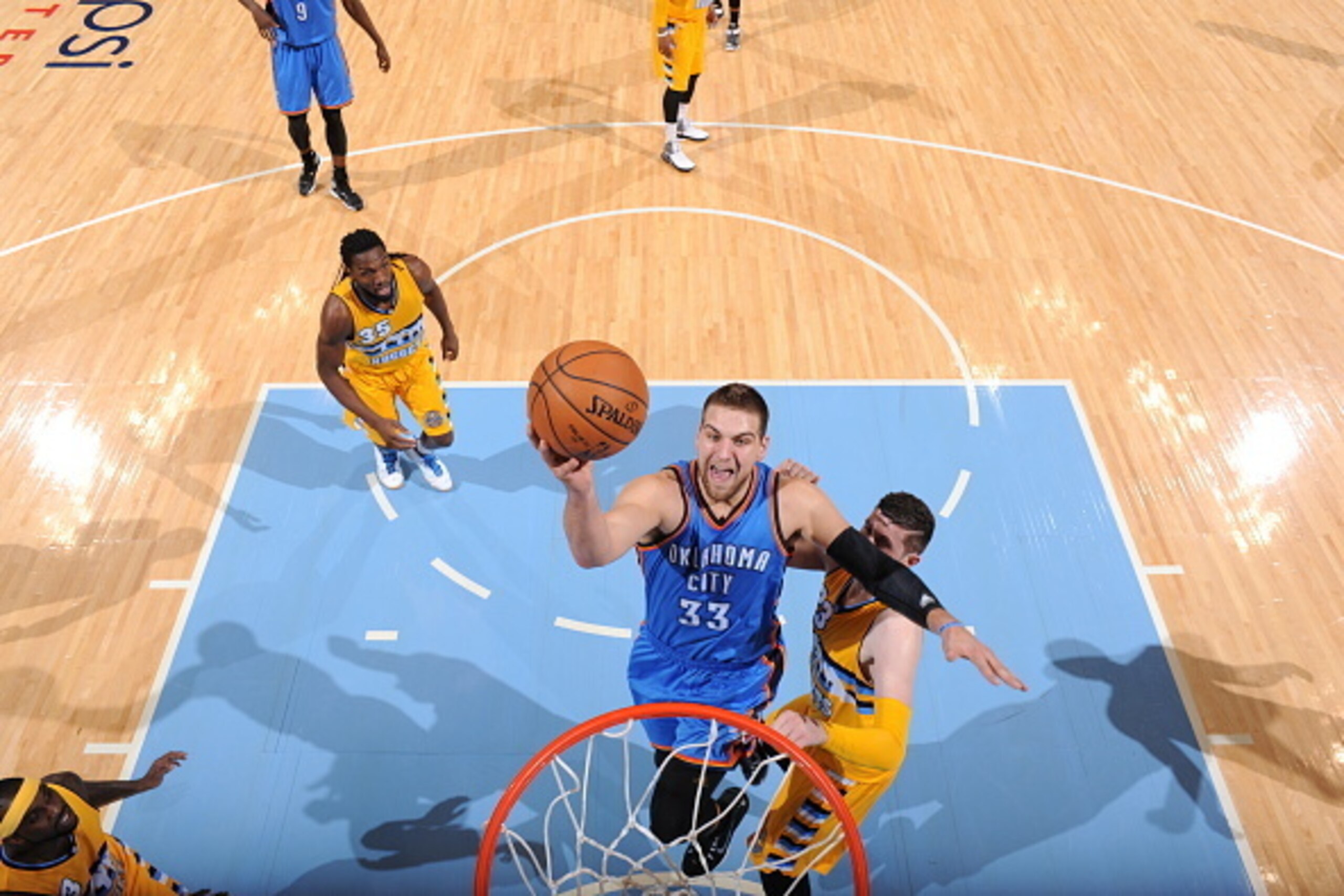 DENVER, CO - FEBRUARY 9: Mitch McGary #33 of the Oklahoma City Thunder shoots against the Denver Nuggets on February 9, 2015 at Pepsi Center in Denver, Colorado. NOTE TO USER: User expressly acknowledges and agrees that, by downloading and or using this P