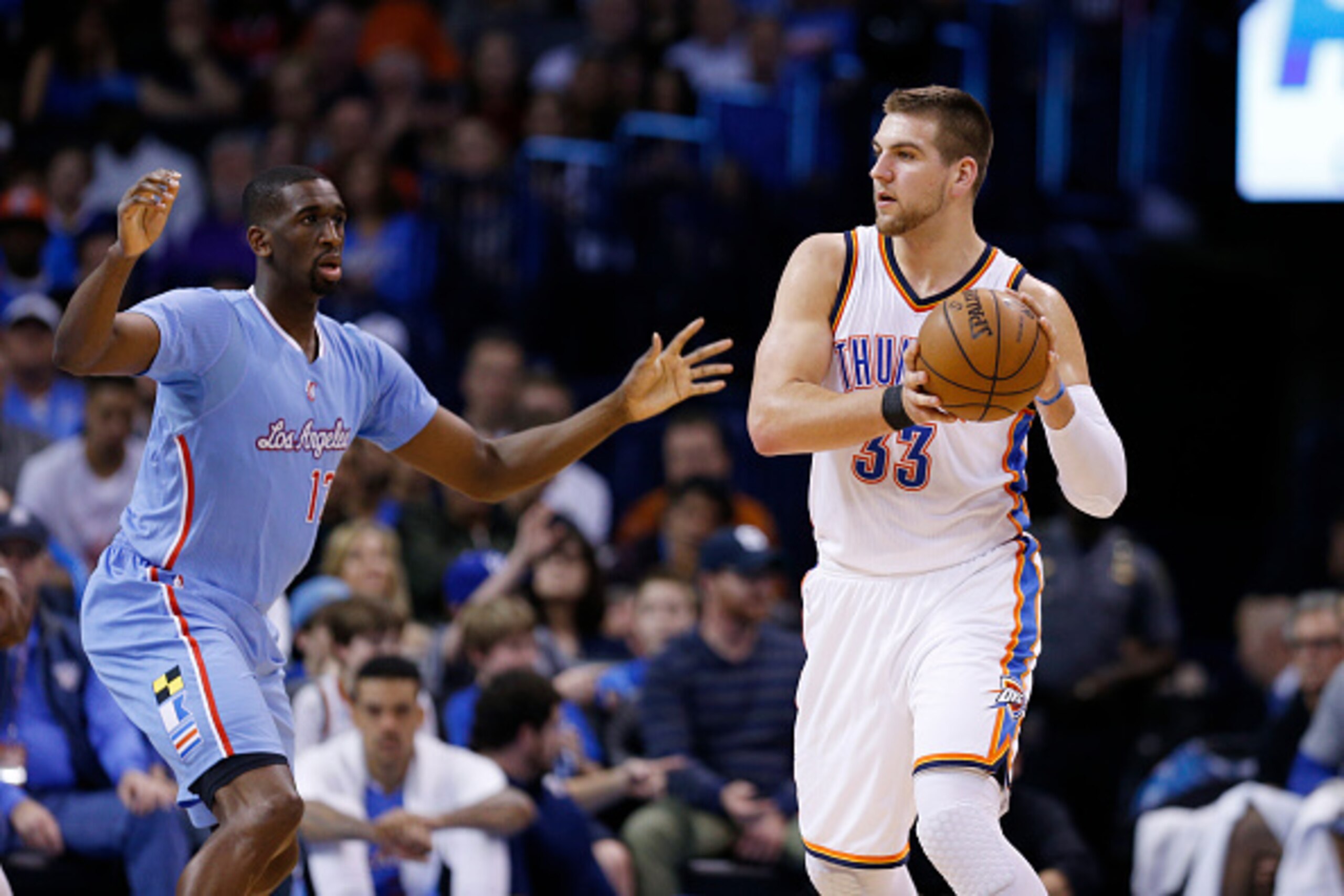 OKLAHOMA CITY, OK - FEBRUARY 8: Mitch McGary #33 of the Oklahoma City Thunder looks to the basket against Ekpe Udoh #13 of the Los Angeles Clippers during the game at Chesapeake Energy Arena on February 8, 2015 in Oklahoma City, Oklahoma. The Thunder defe