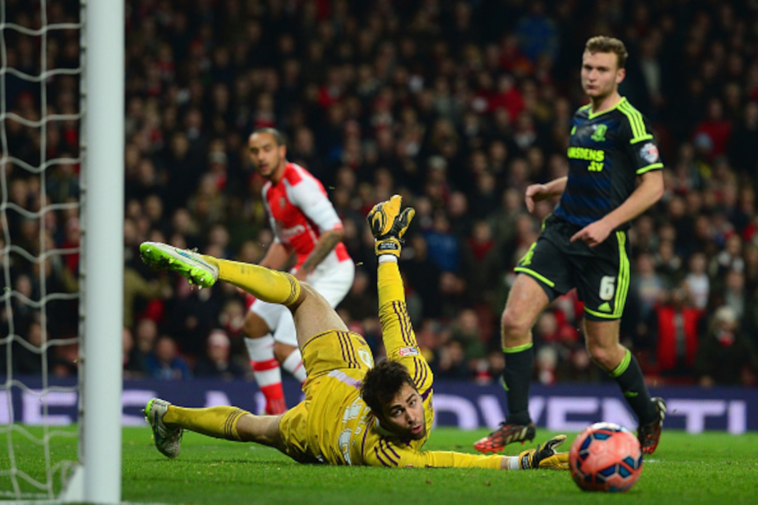 LONDON, ENGLAND - FEBRUARY 15: Tomas Mejias of Middlesbrough puts an effort from Theo Walcott of Arsenal wide of the goal during the FA Cup fifth round match between Arsenal and Middlesbrough at Emirates Stadium on February 15, 2015 in London, England. ( LONDON, ENGLAND - FEBRUARY 15: Tomas Mejias of Middlesbrough puts an effort from Theo Walcott of Arsenal wide of the goal during the FA Cup fifth round match between Arsenal and Middlesbrough at Emirates Stadium on February 15, 2015 in London, England. (