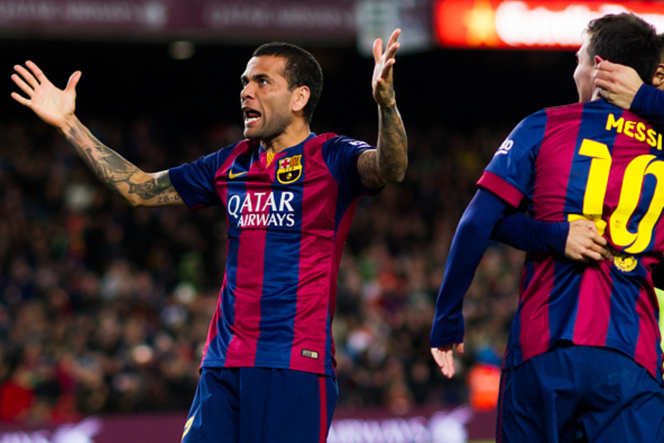 BARCELONA, SPAIN - DECEMBER 07: Dani Alves of FC Barcelona gestures after his teammate Lionel Messi scored his team's second goal during the La Liga match between FC Barcelona and RCD Espanyol at Camp Nou on December 7, 2014 in Barcelona, Spain. (Photo by