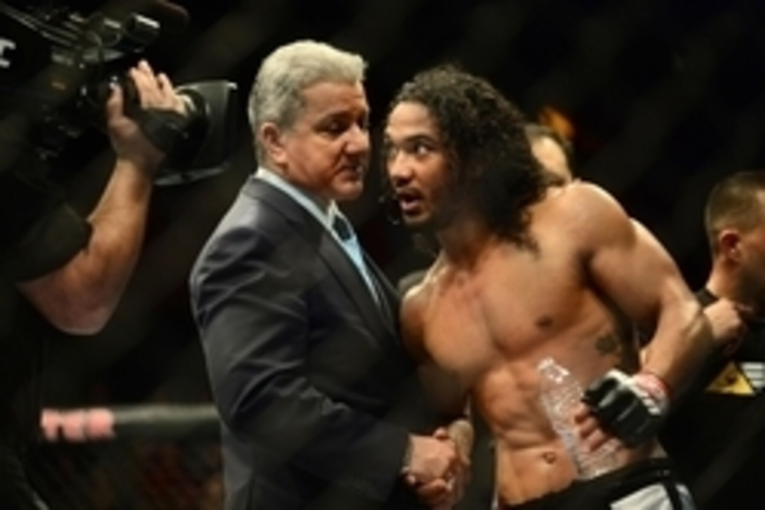 Feb 14, 2015; Broomfield, CO, USA; UFC announcer Bruce Buffer (left) congratulates Benson Henderson (right) following the win over Brandon Thatch (not pictured) in the welterweight bout at the UFC Fight Night at the 1stBANK Center. Mandatory Credit: Ron C
