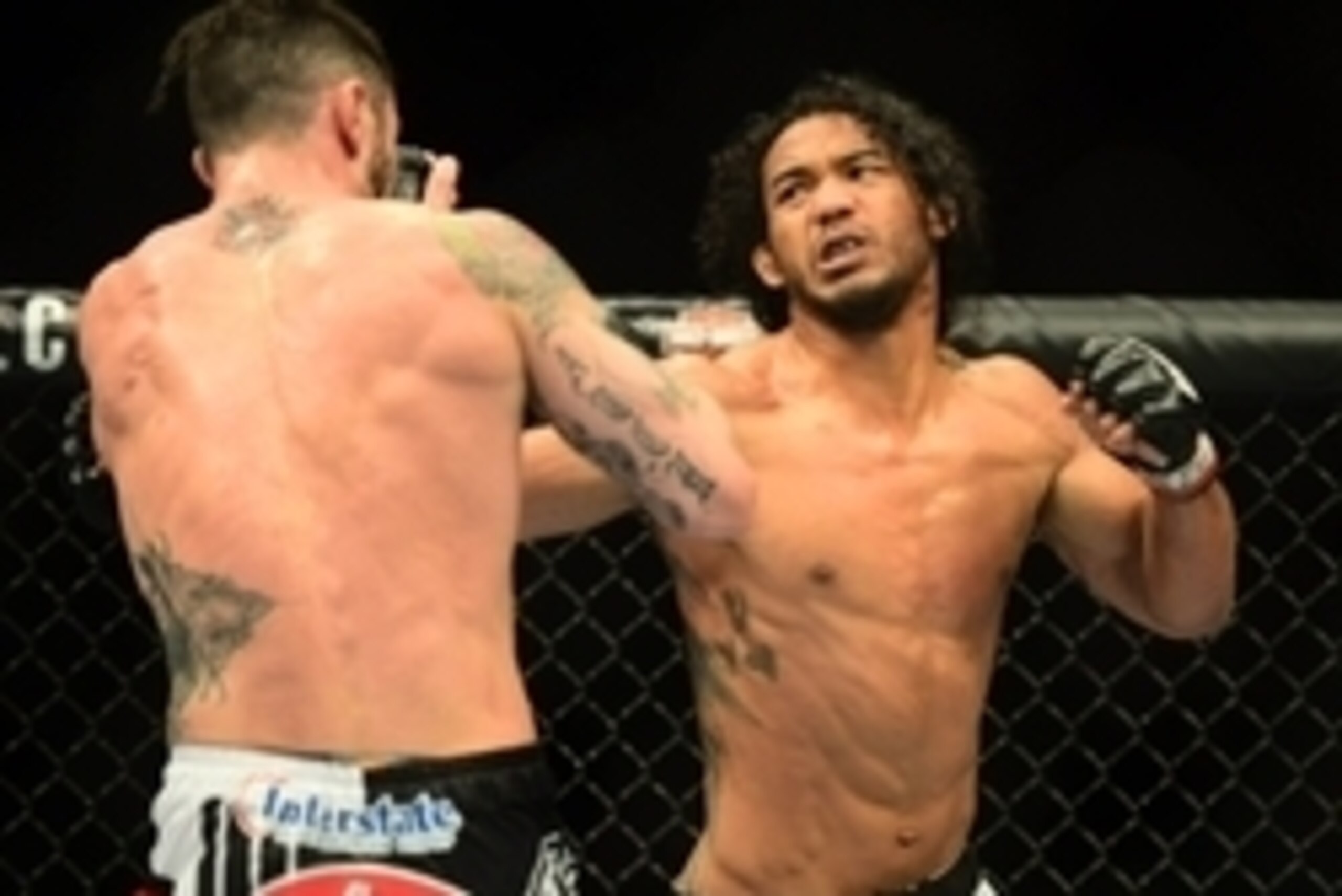 Feb 14, 2015; Broomfield, CO, USA; Brandon Thatch (blue) and Benson Henderson (red) compete in the welterweight bout at the UFC Fight Night at the 1stBANK Center. Mandatory Credit: Ron Chenoy-USA TODAY Sports