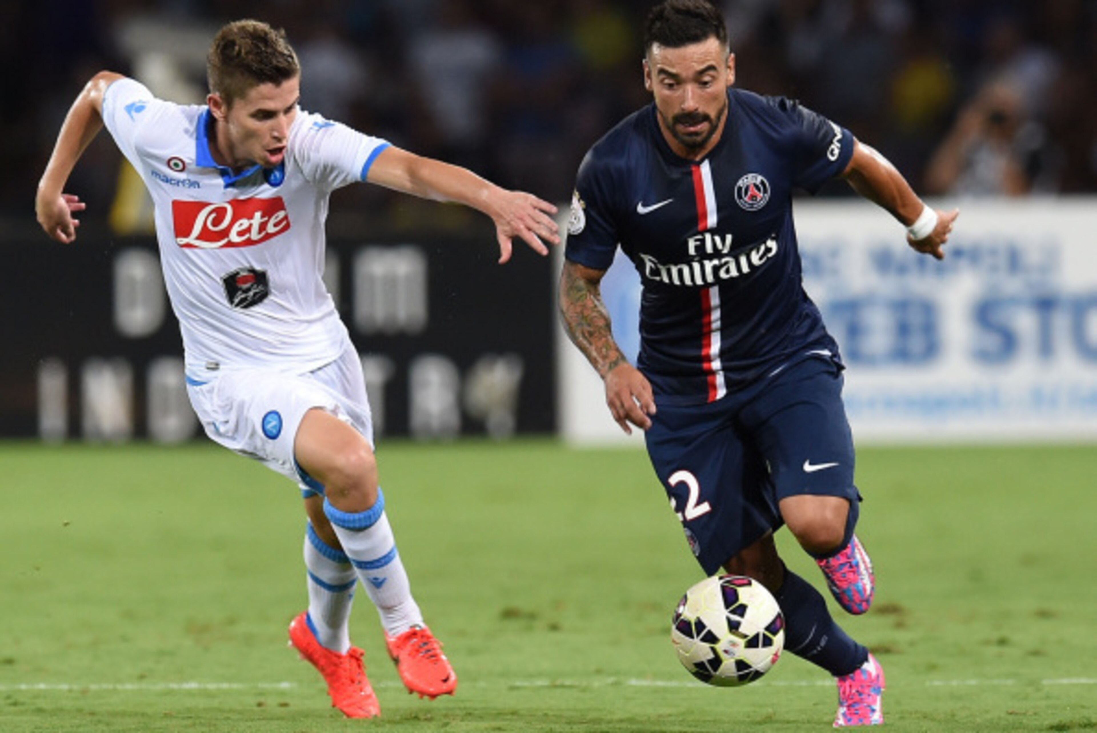 NAPLES, ITALY - AUGUST 11: Jorginho of Napoli and Ezequiel Lavezzi  of Paris Saint Germain in action during the pre-season friendly match between SSC Napoli and Paris Saint-Germain FC at Stadio San Paolo on August 11, 2014 in Naples, Italy.  (Photo by Giu