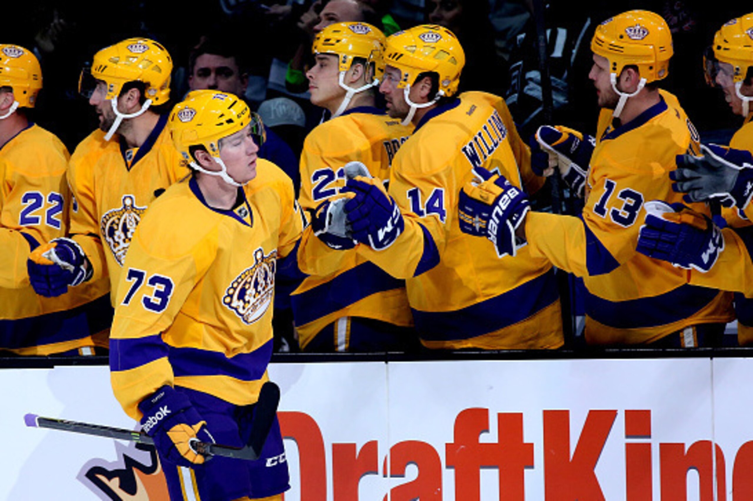 LOS ANGELES, CA - FEBRUARY 12: Tyler Toffoli #73 of the Los Angeles Kings celebrates with teammates as he skates by the bench after scoring a first period goal against the Calgary Flames at Staples Center on February 12, 2015 in Los Angeles, California.  