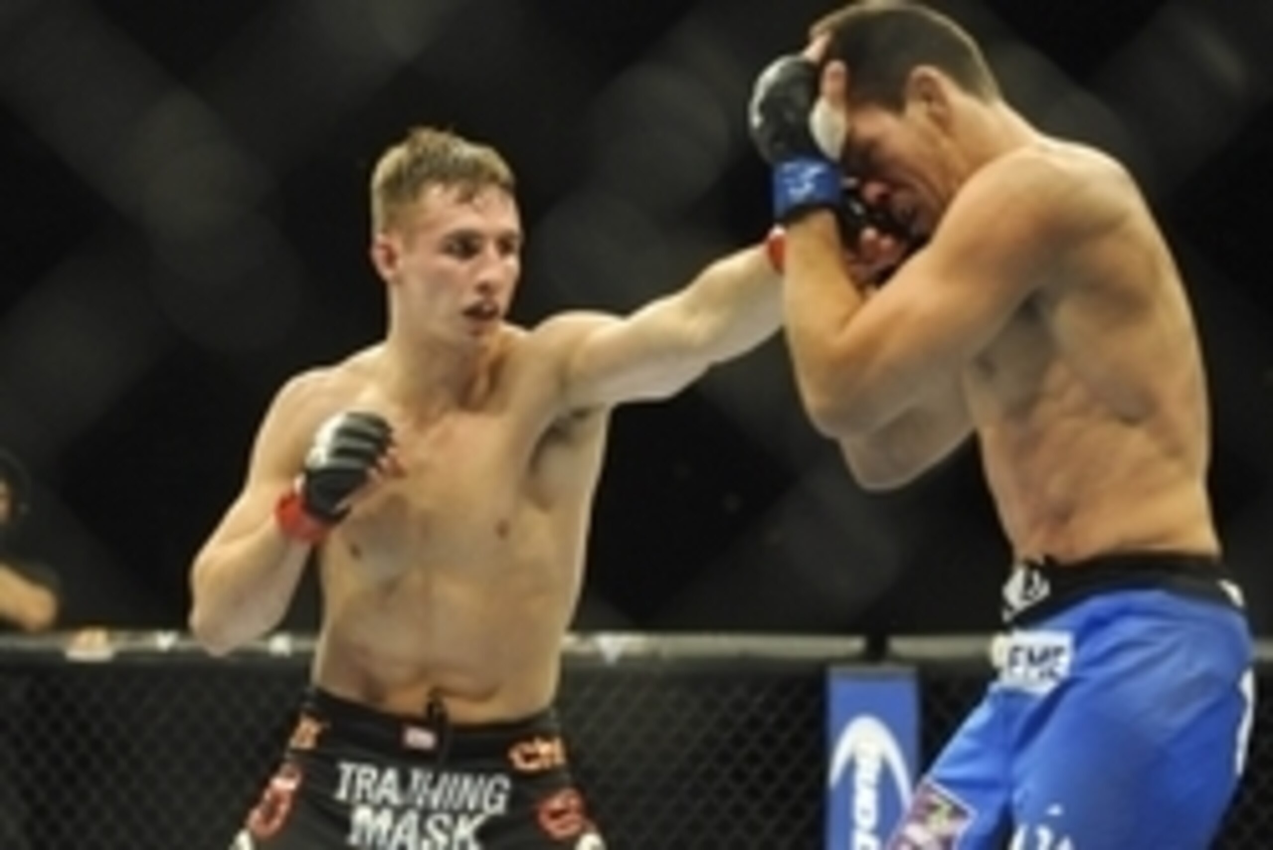 Feb 22, 2014; Las Vegas, NV, USA;  Rory MacDonald (red gloves) lands a punch on Demian Maia (blue gloves) during their UFC welterweight bout at Mandalay Bay. MacDonald won by way of a 29-28 decision. Mandatory Credit: Stephen R. Sylvanie-USA TODAY Sports