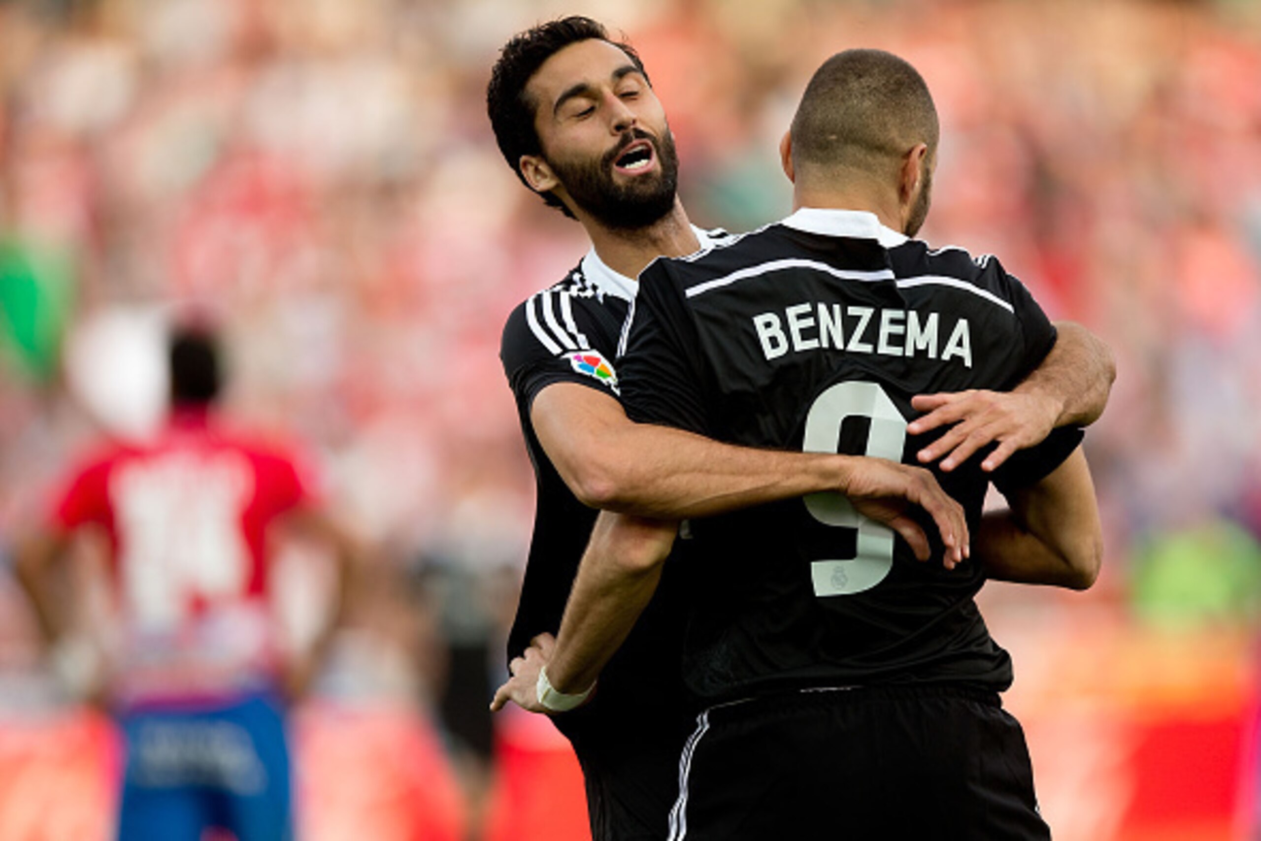 GRANADA, SPAIN - NOVEMBER 01:  Karim Benzema (R) of Real Madrid CF embraces with teammate Alvaro Arbeloa (L) celebrating scoring their third goal during the La Liga match between Granada CF and Real Madrid CF at Nuevo Estadio de Los Carmenes on November 1