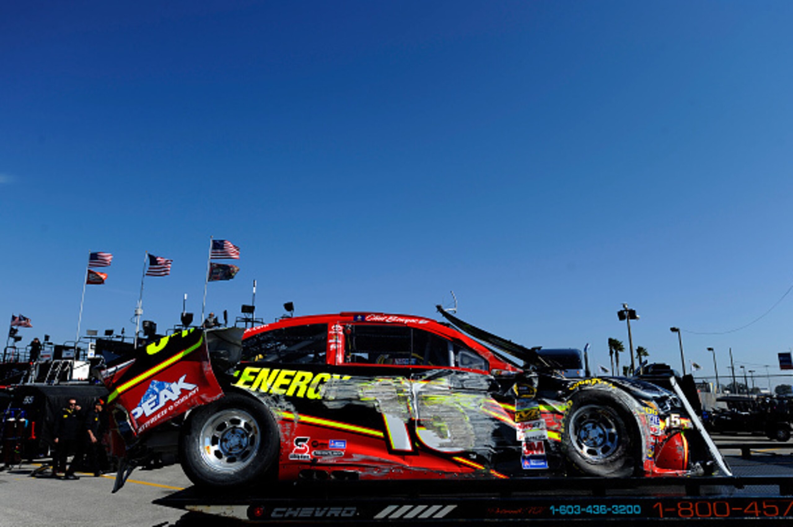 DAYTONA BEACH, FL - FEBRUARY 15:  The wrecked #15 5-hour ENERGY Toyota of Clint Bowyer is towed in the garage area during qualifying for the 57th Annual Daytona 500 at Daytona International Speedway on February 15, 2015 in Daytona Beach, Florida.  (Photo 