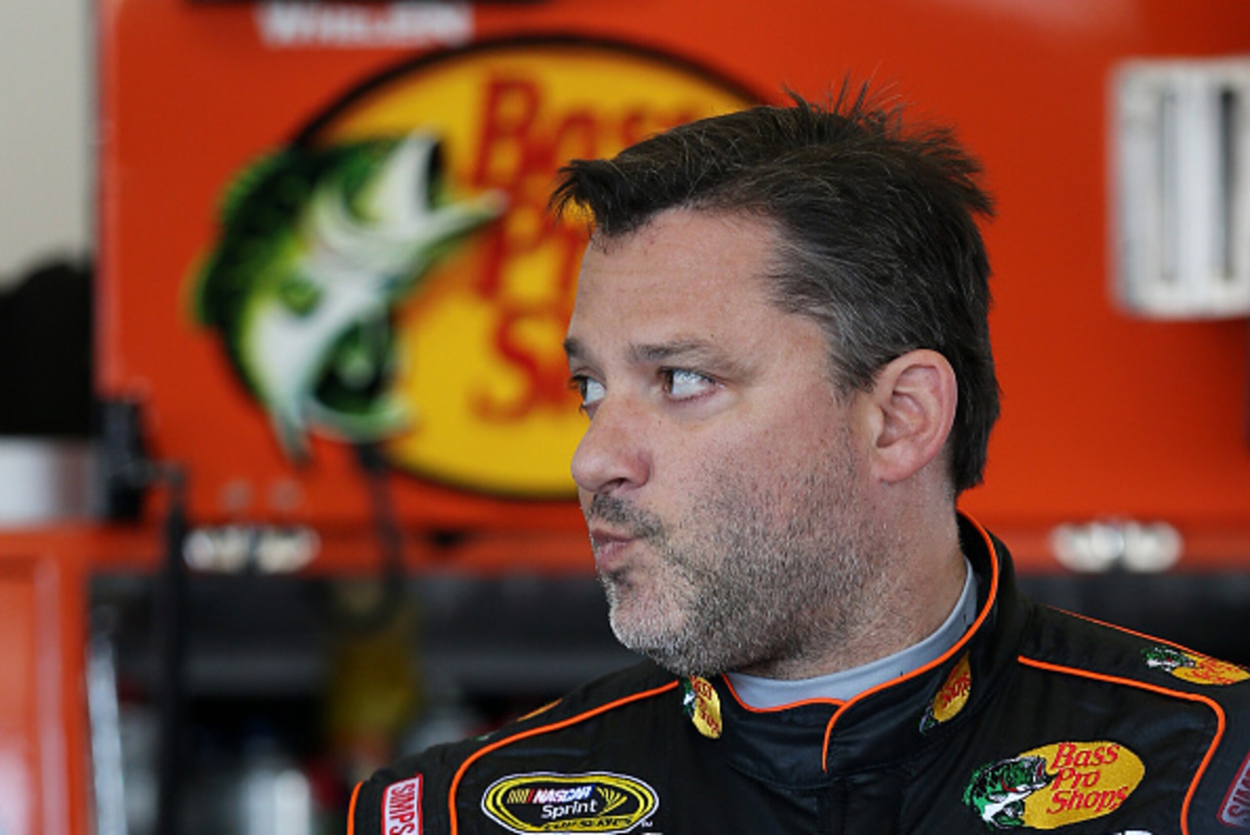 DAYTONA BEACH, FL - FEBRUARY 14:  Tony Stewart, driver of the #14 Bass Pro Shops/Mobil 1 Chevrolet, stands in the garage area during practice for the 57th Annual Daytona 500 at Daytona International Speedway on February 14, 2015 in Daytona Beach, Florida.