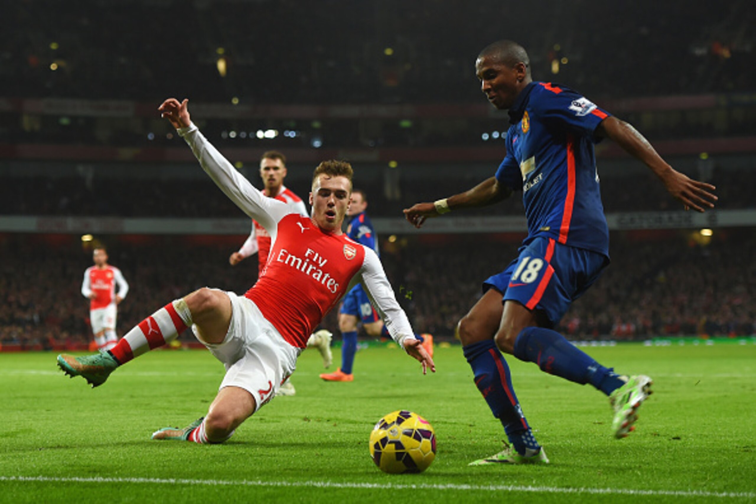 LONDON, ENGLAND - NOVEMBER 22: Calum Chambers of Arsenal closes down Ashley Young of Manchester United during the Barclays Premier League match between Arsenal and Manchester United at Emirates Stadium on November 22, 2014 in London, England.  (Photo by M
