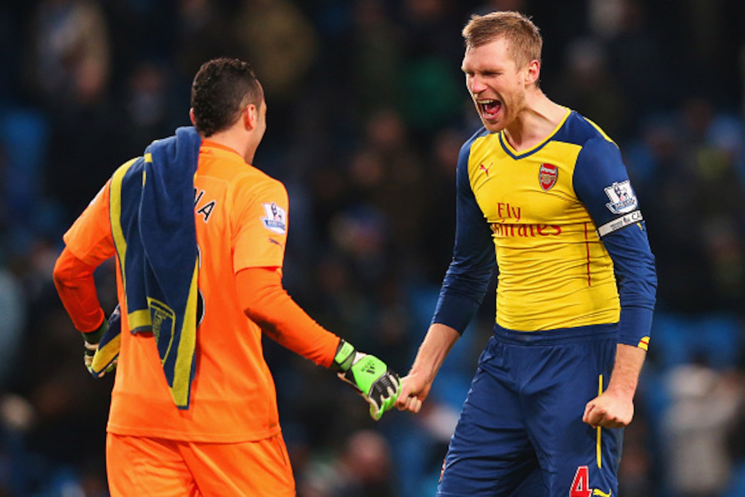 MANCHESTER, ENGLAND - JANUARY 18: David Ospina and Per Mertesacker of Arsenal celebrate victory after the Barclays Premier League match between Manchester City and Arsenal at Etihad Stadium on January 18, 2015 in Manchester, England.  (Photo by Alex Lives