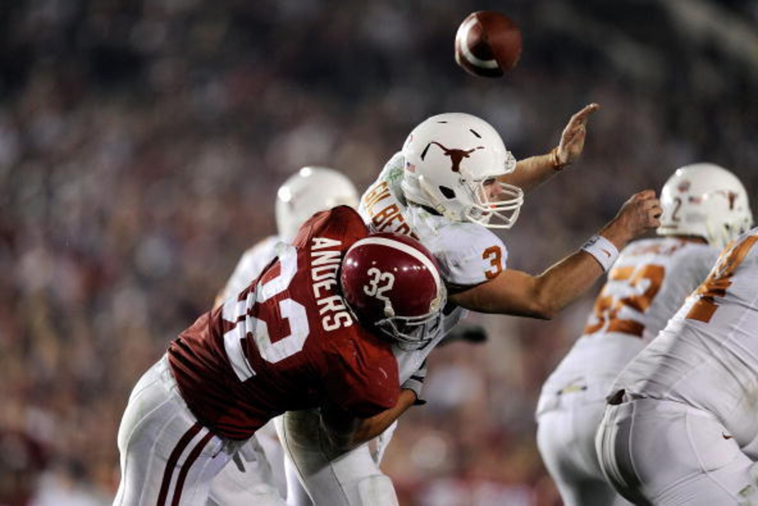 PASADENA, CA - JANUARY 07:  Quarterback Garrett Gilbert #3 of the Texas Longhorns fumbles the ball as he is hit by linebacker Eryk Anders #32 of the Alabama Crimson Tide during the Citi BCS National Championship game at the Rose Bowl on January 7, 2010 in