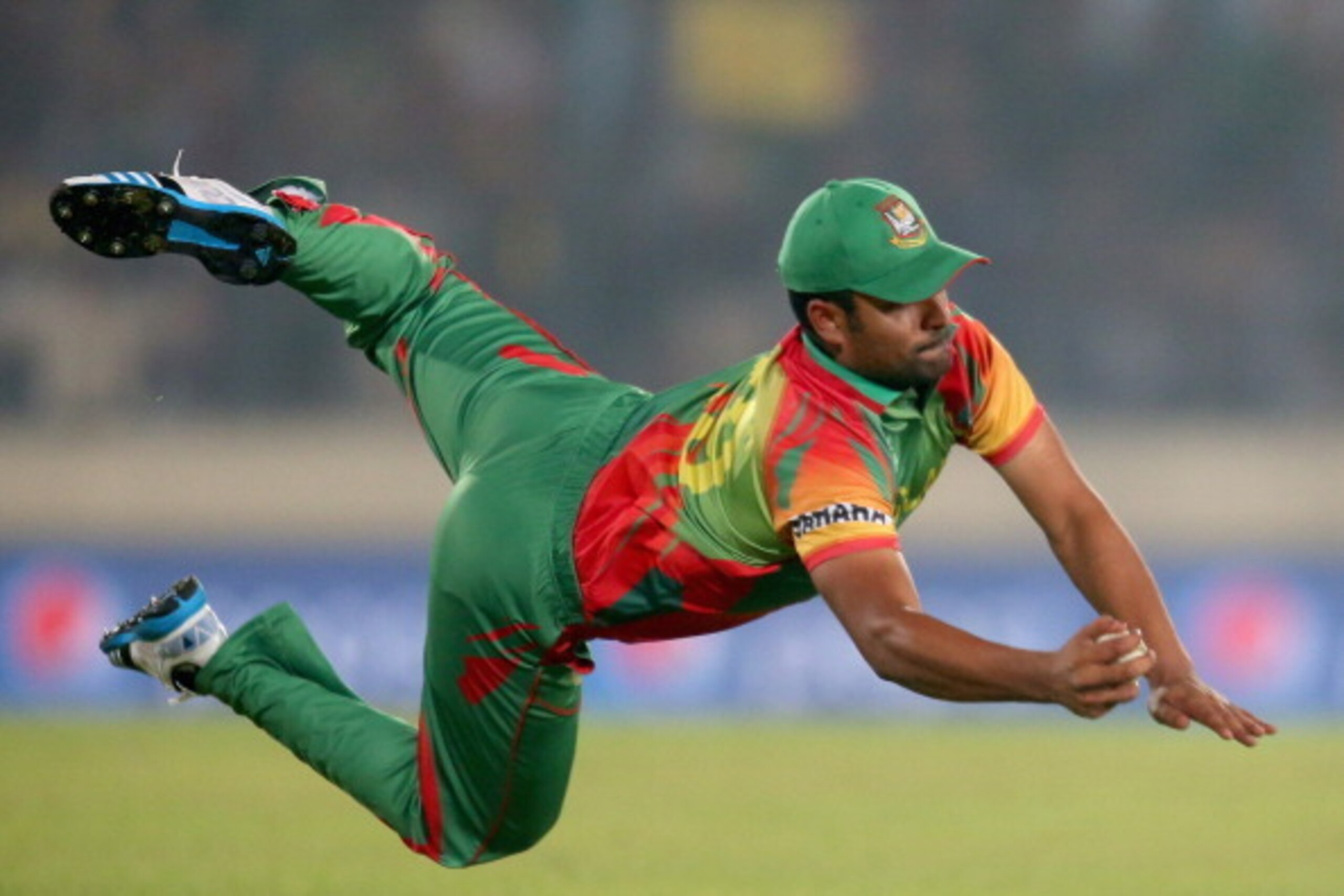 DHAKA, BANGLADESH - MARCH 25:  Tamim Iqbal of Bangladesh takes a diving catch to dismiss Dwayne Bravo of the West Indies during the ICC World Twenty20 Bangladesh 2014 match between Bangladesh and the West Indies at Sher-e-Bangla Mirpur Stadium on March 25