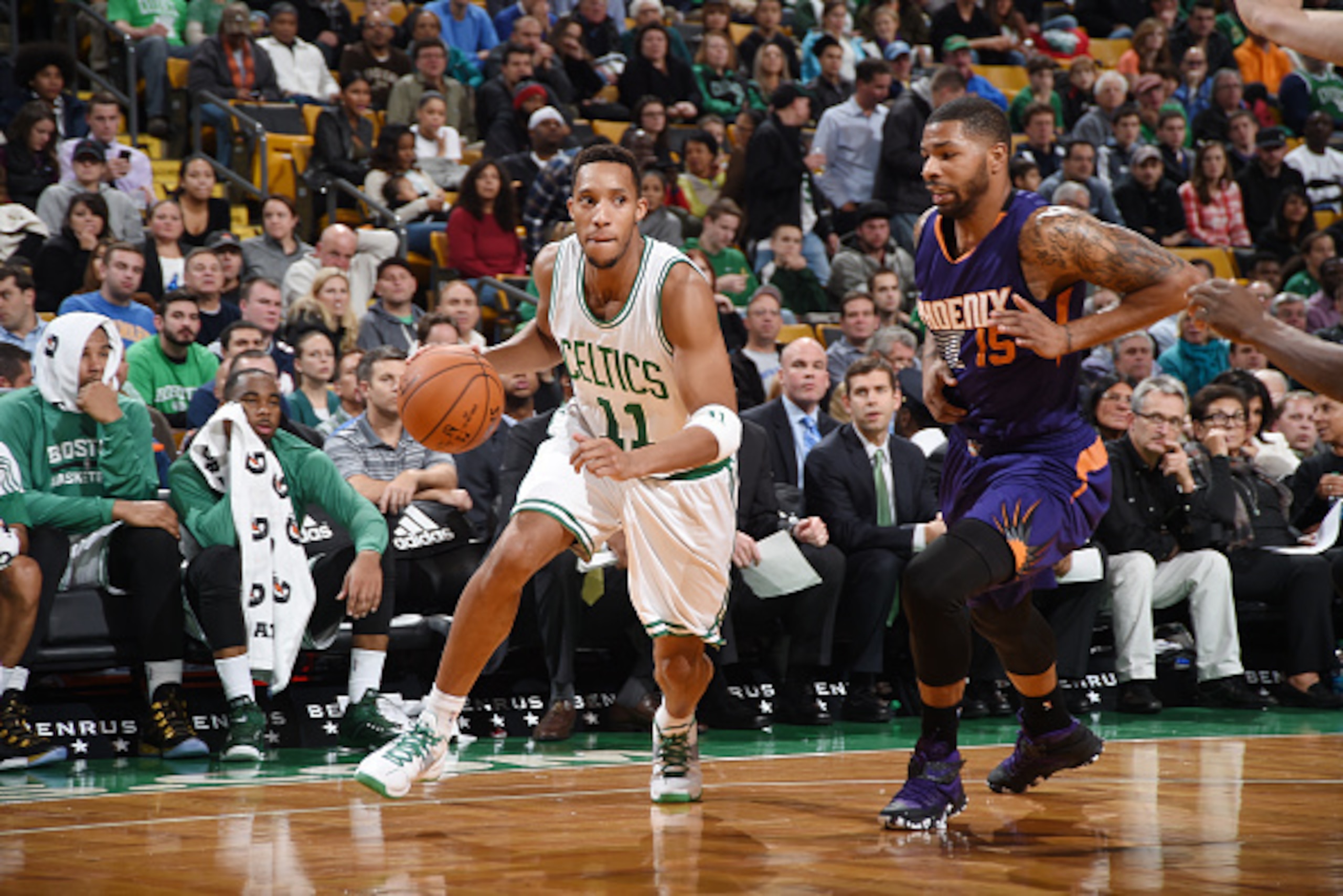 BOSTON, MA - NOVEMBER 17: Evan Turner #11 of the Boston Celtics drives to the basket against Marcus Morris #15 of the Phoenix Suns during the game on November 17, 2014 at TD Garden in Boston, Massachusetts. NOTE TO USER: User expressly acknowledges and ag