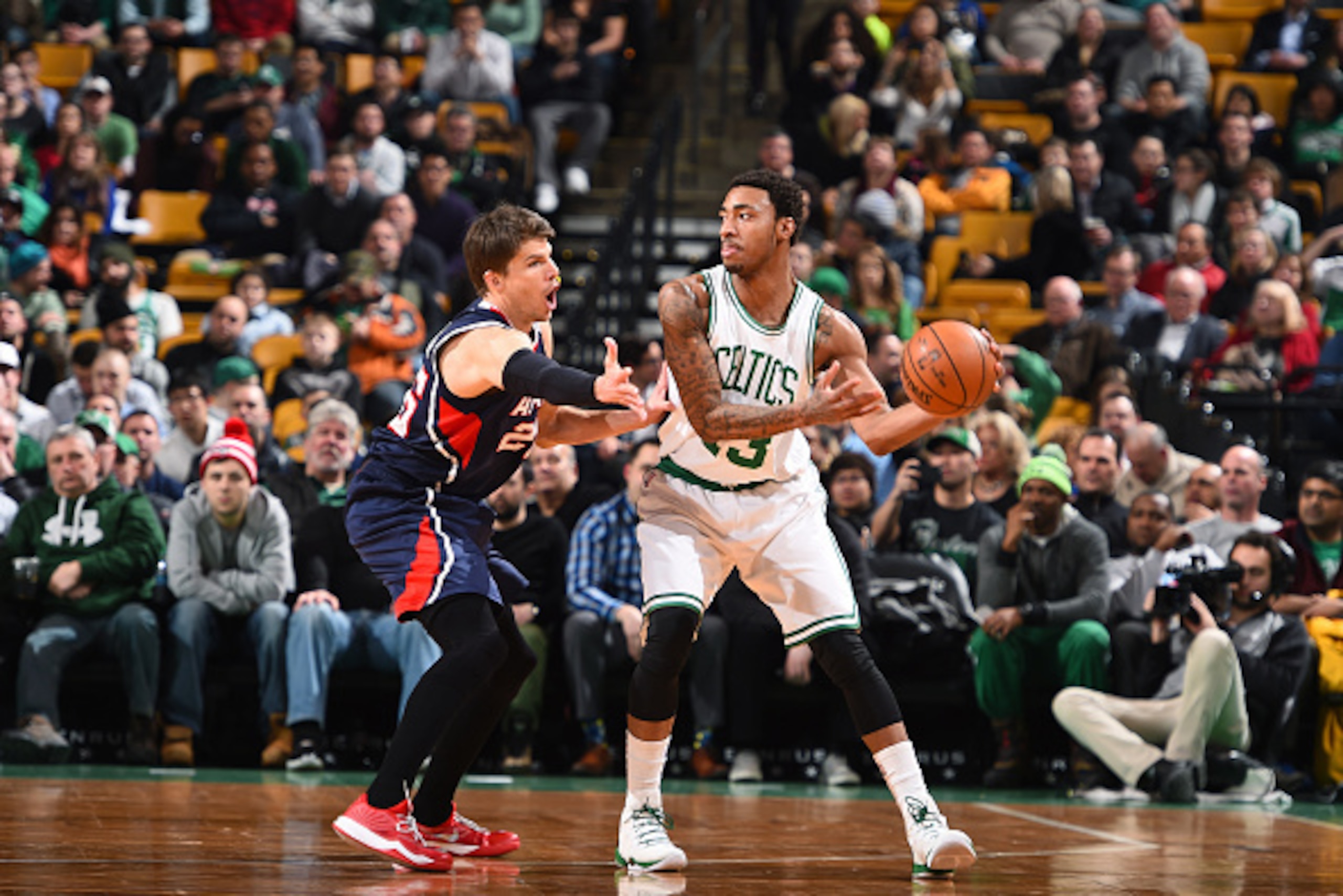 BOSTON, MA -  FEBRUARY 11: James Young #13 of the Boston Celtics moves the ball against Kyle Korver #26 of the Atlanta Hawks during the game on February 11, 2015 at TD Garden in Boston, Massachusetts. NOTE TO USER: User expressly acknowledges and agrees t