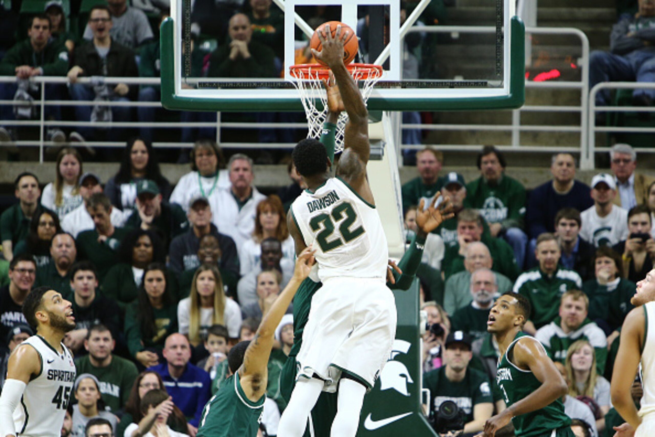 EAST LANSING, MI - DECEMBER 17: Branden Dawson #22 of the Michigan State Spartans goes up for a dunk and draws a foul from Olalekan Ajayi #12 of the Eastern Michigan Eagles in the second half at the Breslin Center on December 17, 2014 in East Lansing, Mic EAST LANSING, MI - DECEMBER 17: Branden Dawson #22 of the Michigan State Spartans goes up for a dunk and draws a foul from Olalekan Ajayi #12 of the Eastern Michigan Eagles in the second half at the Breslin Center on December 17, 2014 in East Lansing, Mic