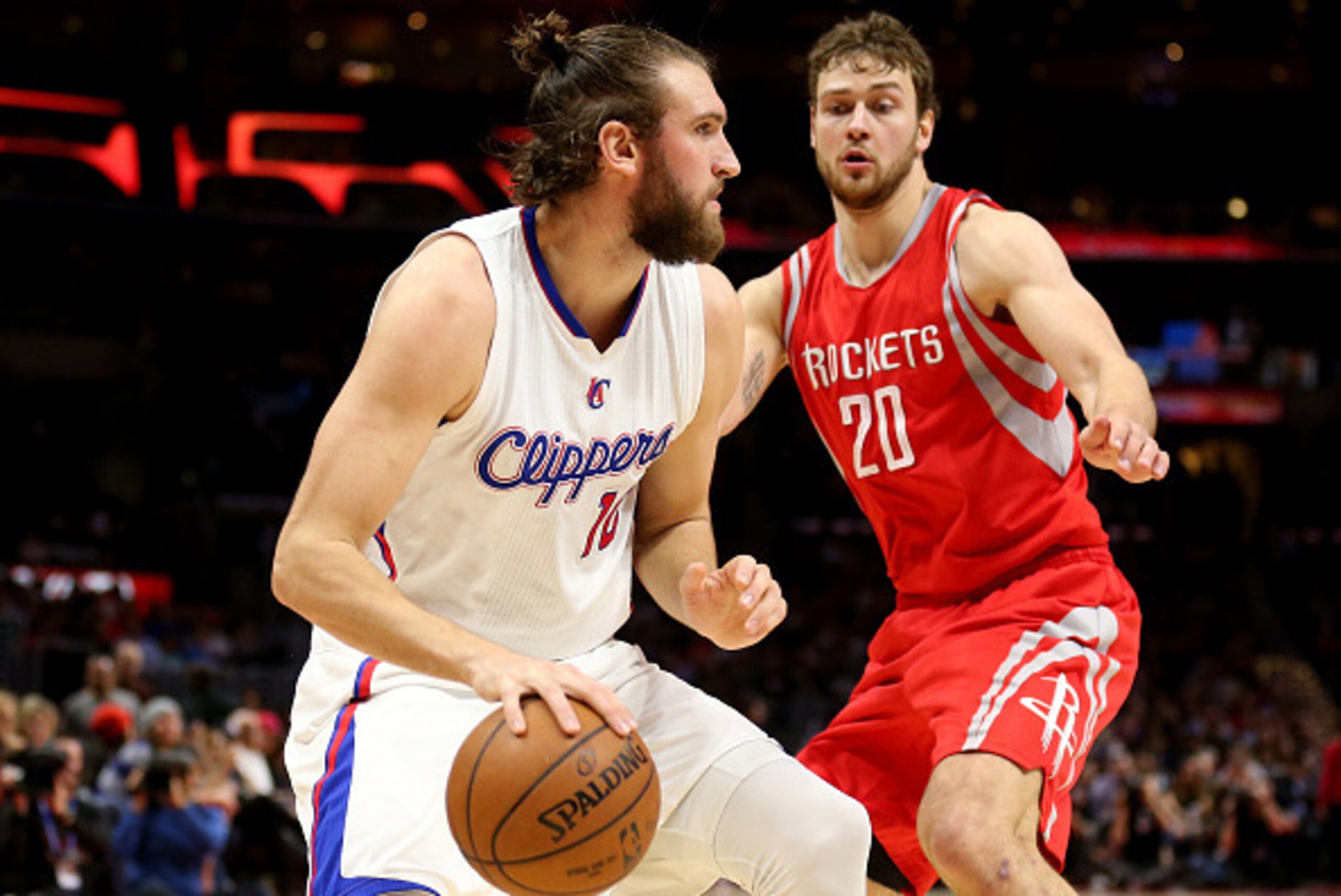 LOS ANGELES, CA - FEBRUARY 11:  Spencer Hawes #10 of the Los Angeles Clippers dribbles the ball against Donatas Motiejunas #20 of the Houston Rockets at Staples Center on February 11, 2015 in Los Angeles, California.  NOTE TO USER: User expressly acknowle