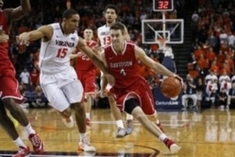 Dec 30, 2014; Charlottesville, VA, USA; Davidson Wildcats guard Tyler Kalinoski (4) dibbles the ball around Virginia Cavaliers guard Malcolm Brogdon (15) in the first half at John Paul Jones Arena. Mandatory Credit: Amber Searls-USA TODAY Sports