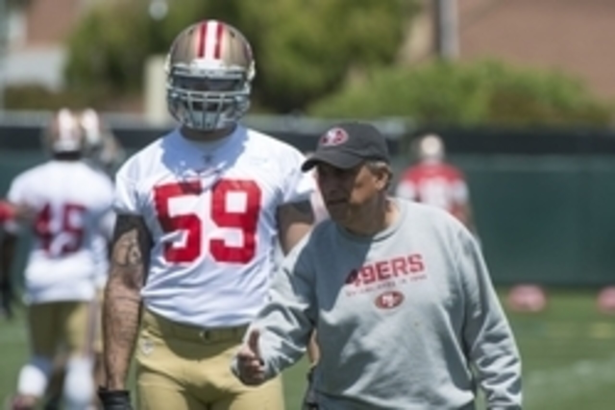 May 28, 2014; Santa Clara, CA, USA; San Francisco 49ers defensive coordinator Vic Fangio (right) instructs linebacker Aaron Lynch (59) during organized team activities at the SAP Performance Facility. Mandatory Credit: Kyle Terada-USA TODAY Sports