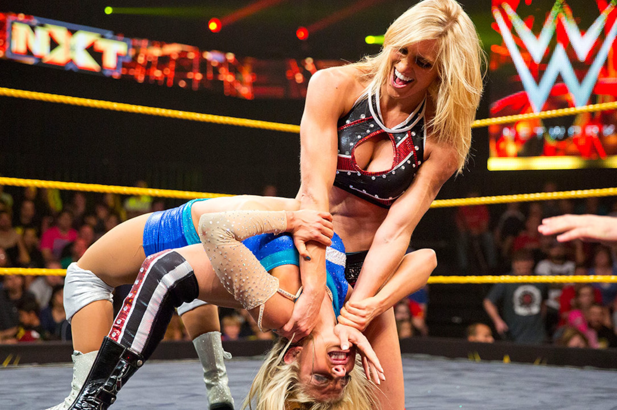 Charlotte puts a hurting on Alexa Bliss.