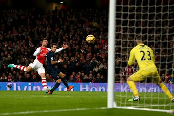 LONDON, ENGLAND - DECEMBER 03:  Olivier Giroud of Arsenal shoots at goal under pressure from Jose Fonte of Southampton during the Barclays Premier League match between Arsenal and Southampton at Emirates Stadium on December 3, 2014 in London, England.  (P