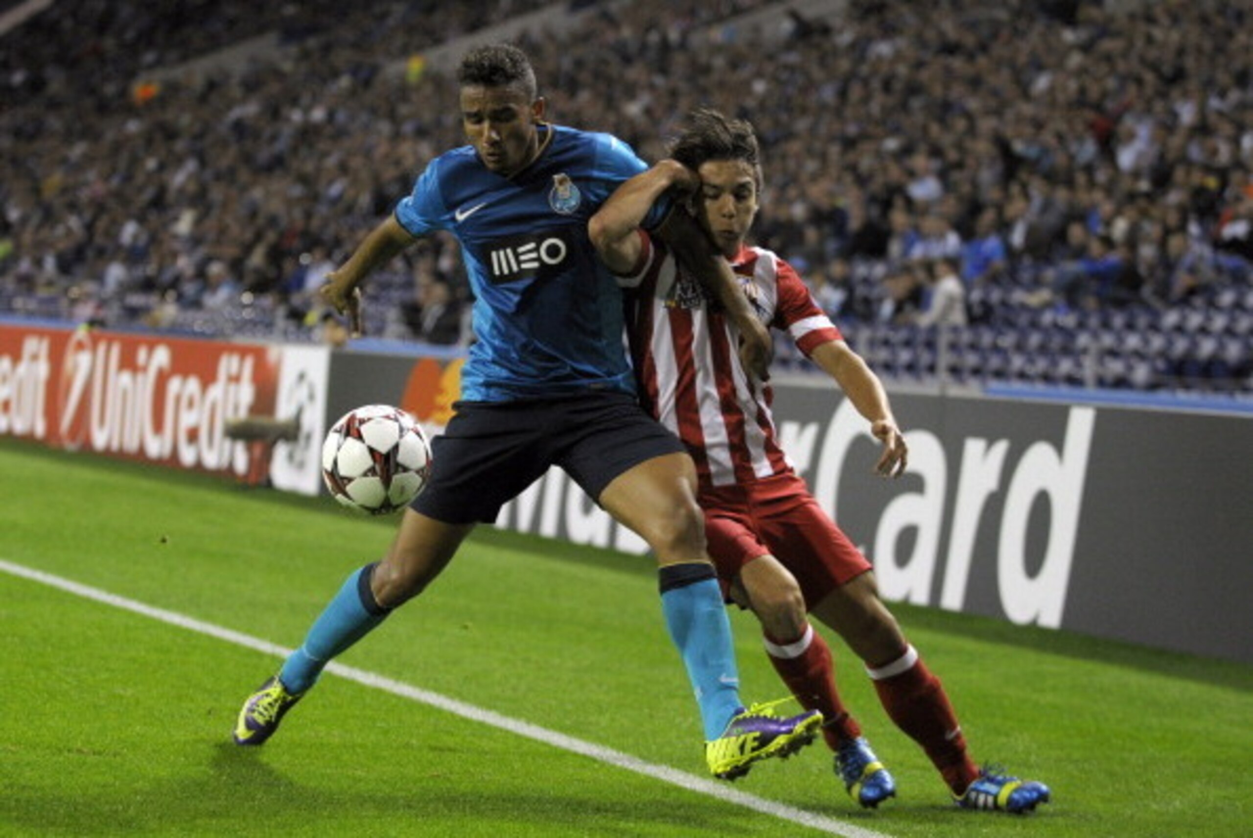 PORTO, PORTUGAL - OCTOBER 1:  Oliver Torres (R) of Club Atletico de Madrid challenges Danilo of FC Porto during the UEFA Champions League group stage match between FC Porto and Club Atletico de Madrid held on October 1, 2013 at the Estadio do Dragao, in P