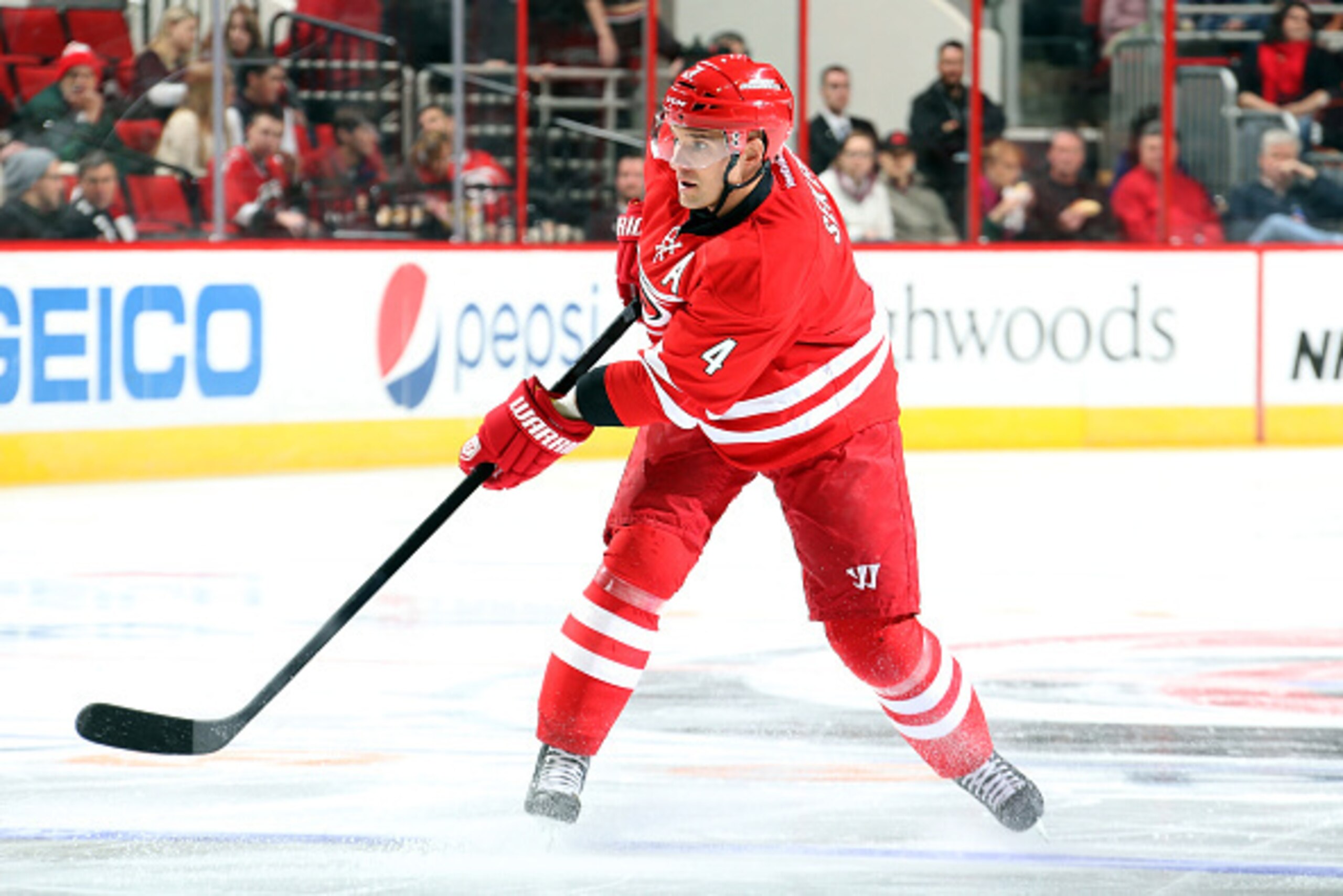 RALEIGH, NC - FEBRUARY 12: Andrej Sekera #4 of the Carolina Hurricanes releases a pass during the first period of an NHL game against the Anaheim Ducks at PNC Arena on Febuary 12, 2015 in Raleigh, North Carolina.  (Photo by Gregg Forwerck/NHLI via Getty I