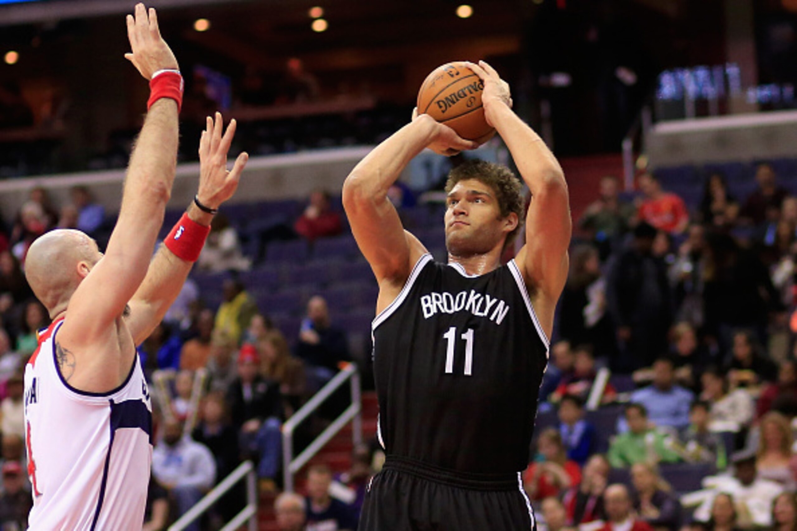 WASHINGTON, DC - FEBRUARY 07: Brook Lopez #11 of the Brooklyn Nets puts up a shot in front of Marcin Gortat #4 of the Washington Wizards during the first half at Verizon Center on February 7, 2015 in Washington, DC. NOTE TO USER: User expressly acknowledg