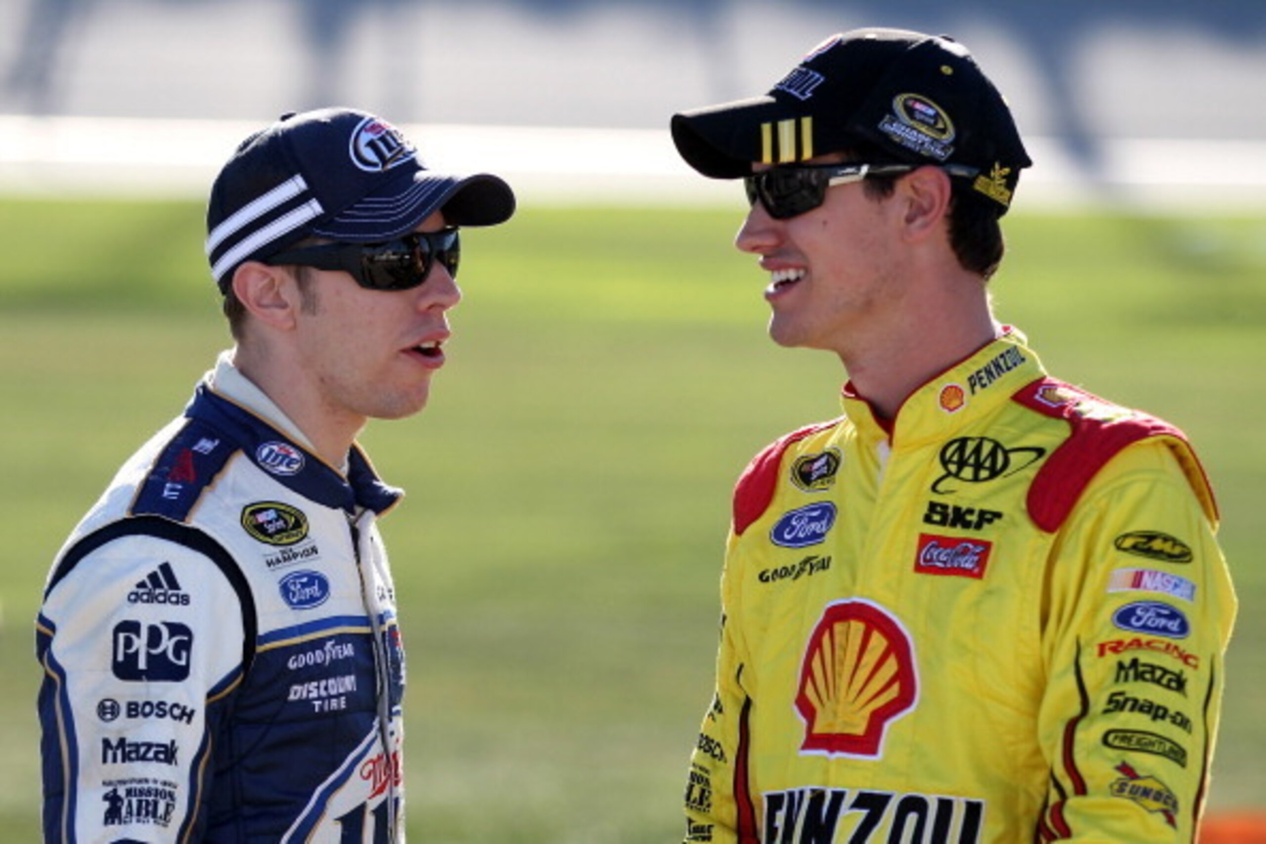 JOLIET, IL - SEPTEMBER 13:  Brad Keselowski, driver of the #2 Miller Lite Ford, and Joey Logano, driver of the #22 Shell-Pennzoil Ford, speak on pit road during qualifying for the NASCAR Sprint Cup Series Geico 400 at Chicagoland Speedway on September 13,