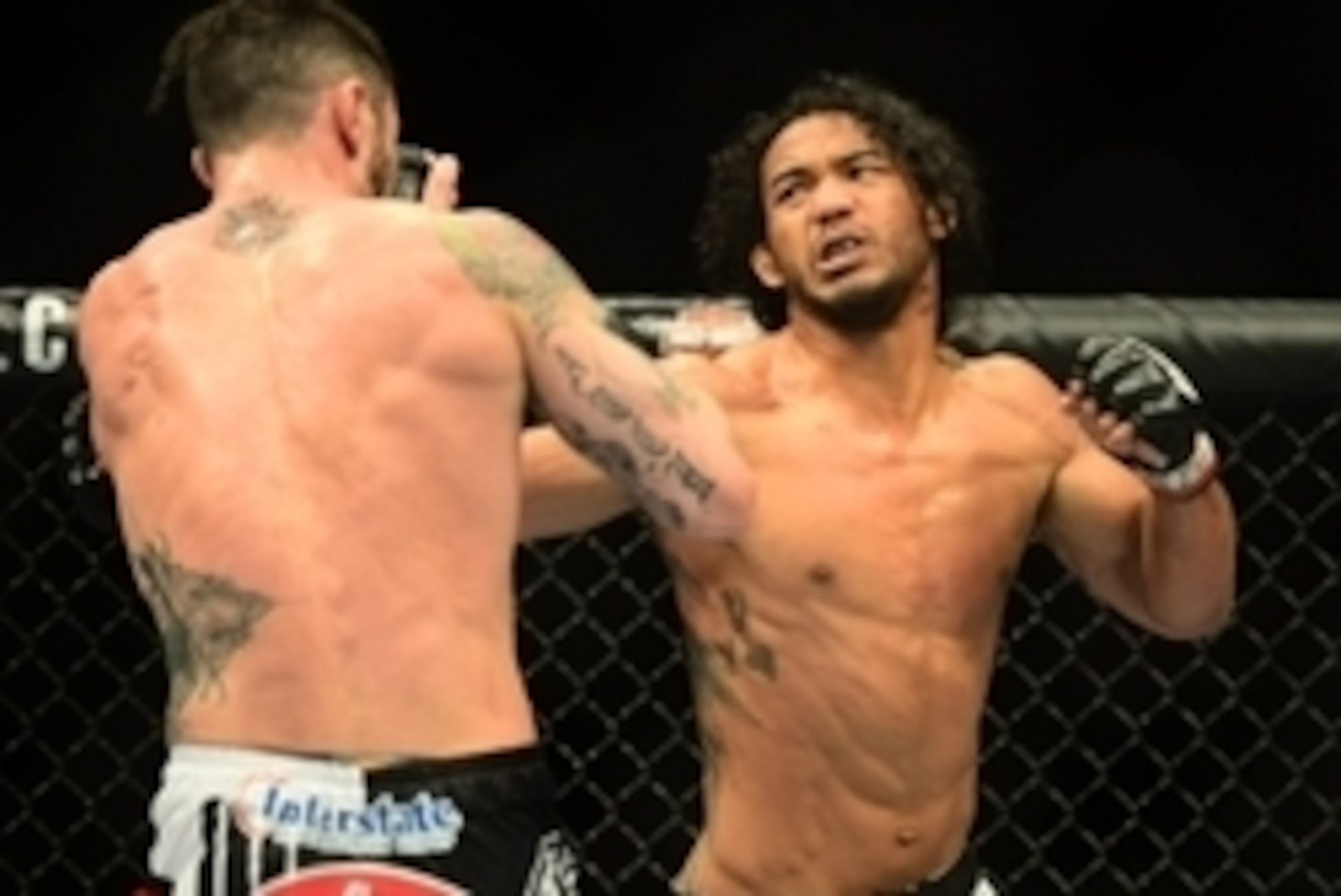 Feb 14, 2015; Broomfield, CO, USA; Brandon Thatch (blue) and Benson Henderson (red) compete in the welterweight bout at the UFC Fight Night at the 1stBANK Center. Mandatory Credit: Ron Chenoy-USA TODAY Sports