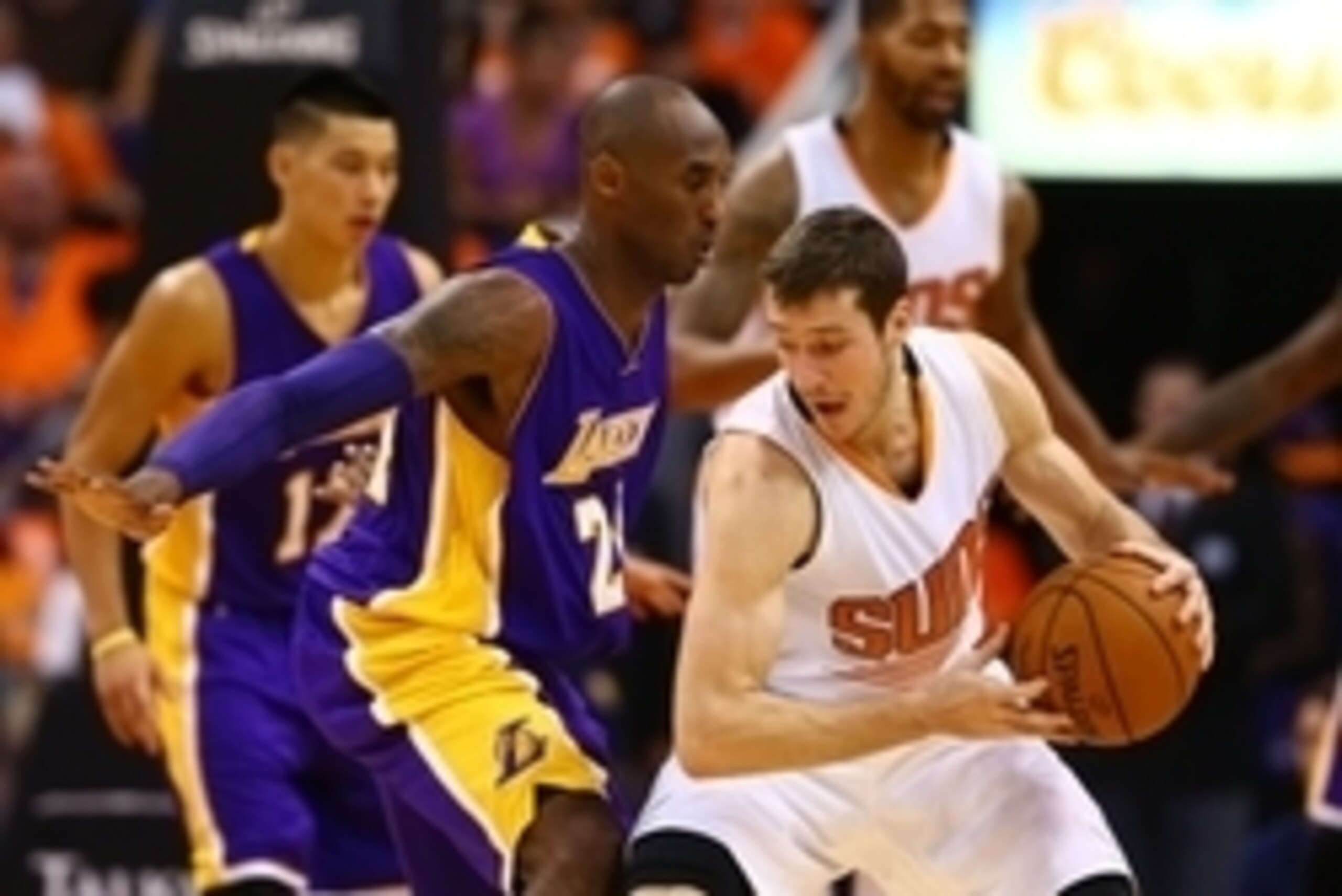 Oct 29, 2014; Phoenix, AZ, USA; Phoenix Suns guard Goran Dragic (right) drives to the basket against Los Angeles Lakers guard Kobe Bryant in the second half during the home opener at US Airways Center. The Suns defeated the Lakers 119-99. Mandatory Credit