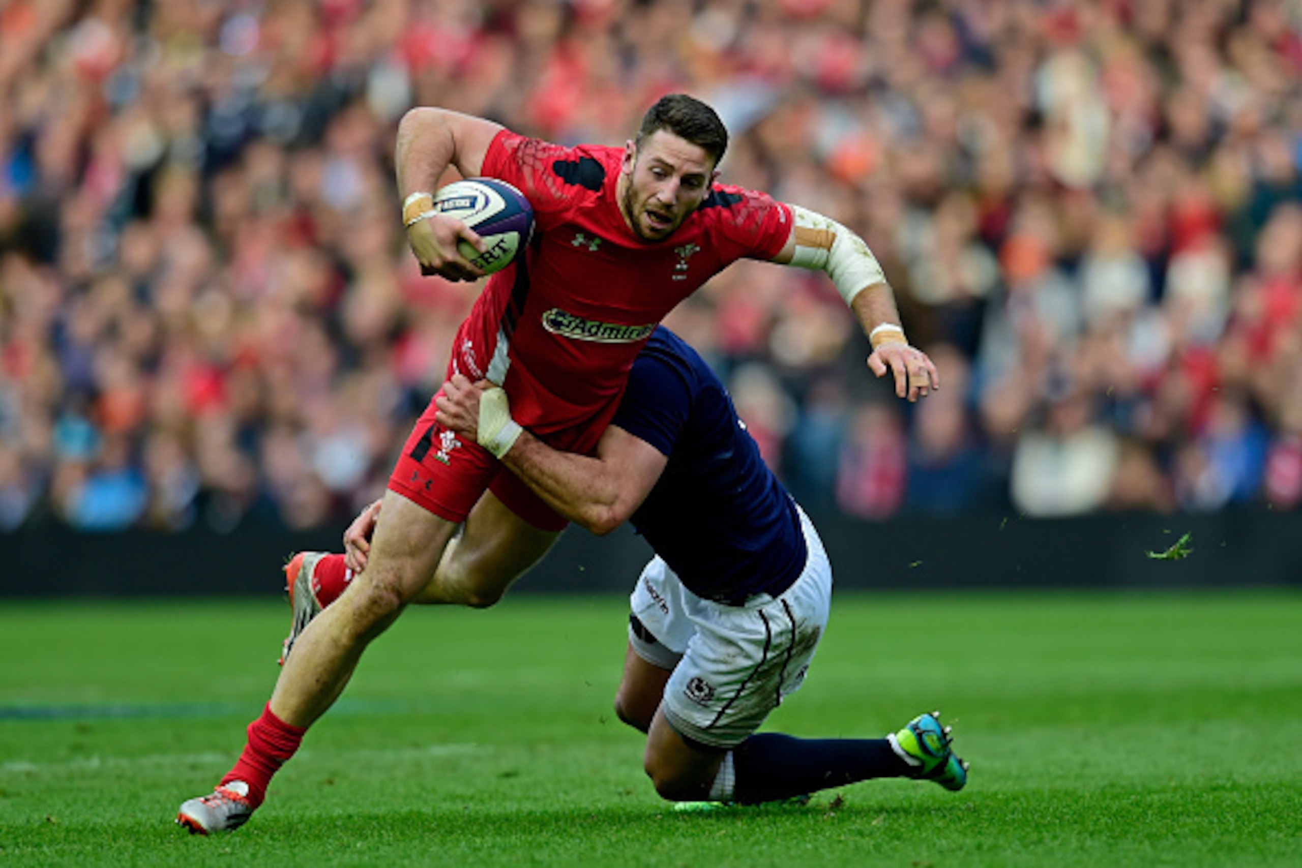 EDINBURGH, SCOTLAND - FEBRUARY 15:  Alex Cuthbert of Wales is tackled by Alex Dunbar of Scotland during the RBS Six Nations match between Scotland and Wales at Murrayfield Stadium on February 15, 2015 in Edinburgh, Scotland.  (Photo by Stu Forster/Getty I