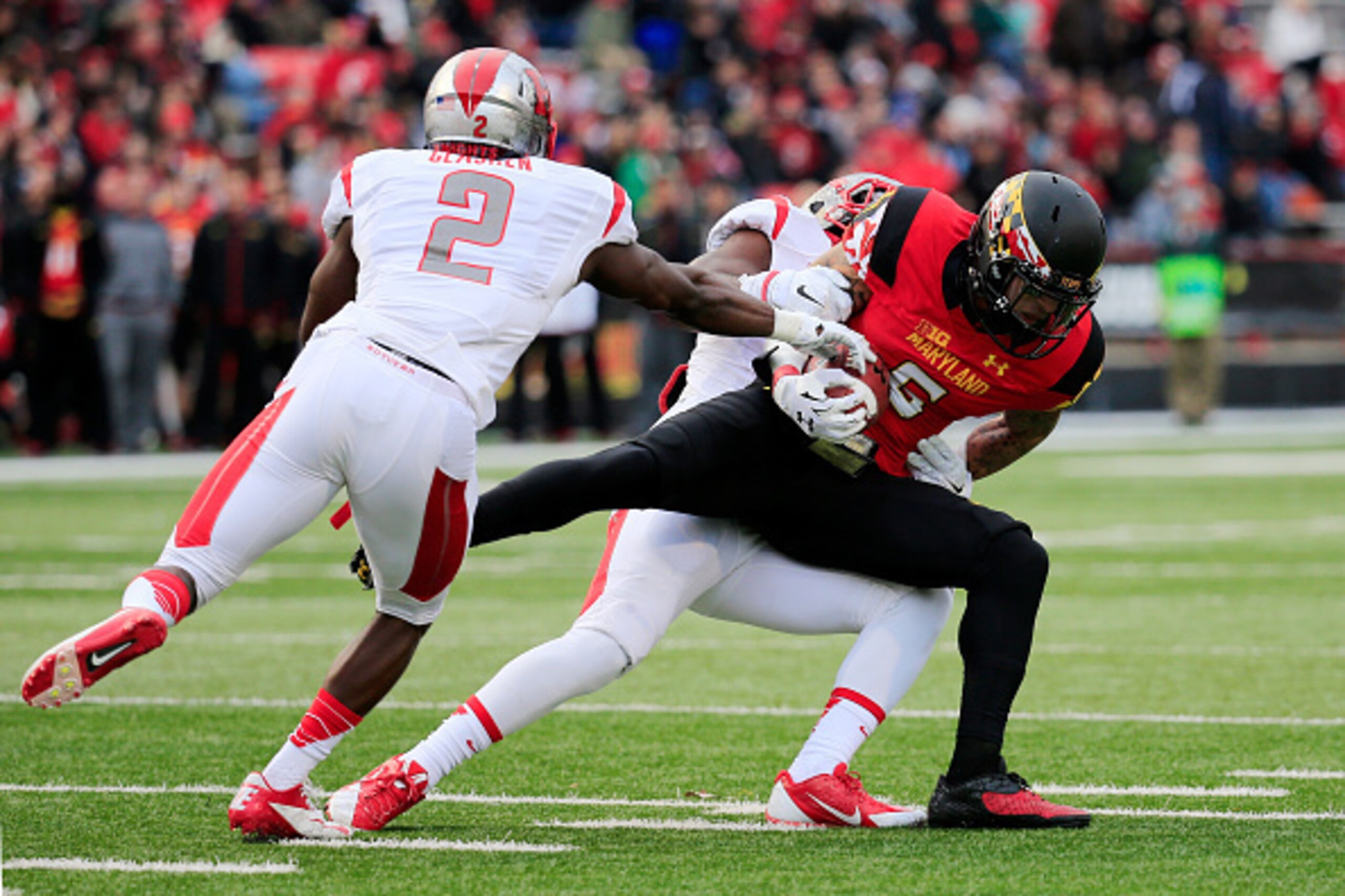 COLLEGE PARK, MD - NOVEMBER 29: Wide receiver Deon Long #6 of the Maryland Terrapins is tackled by defensive back Gareef Glashen #2 and defensive back Lorenzo Waters #21 of the Rutgers Scarlet Knights during the first half at Byrd Stadium on November 29, 