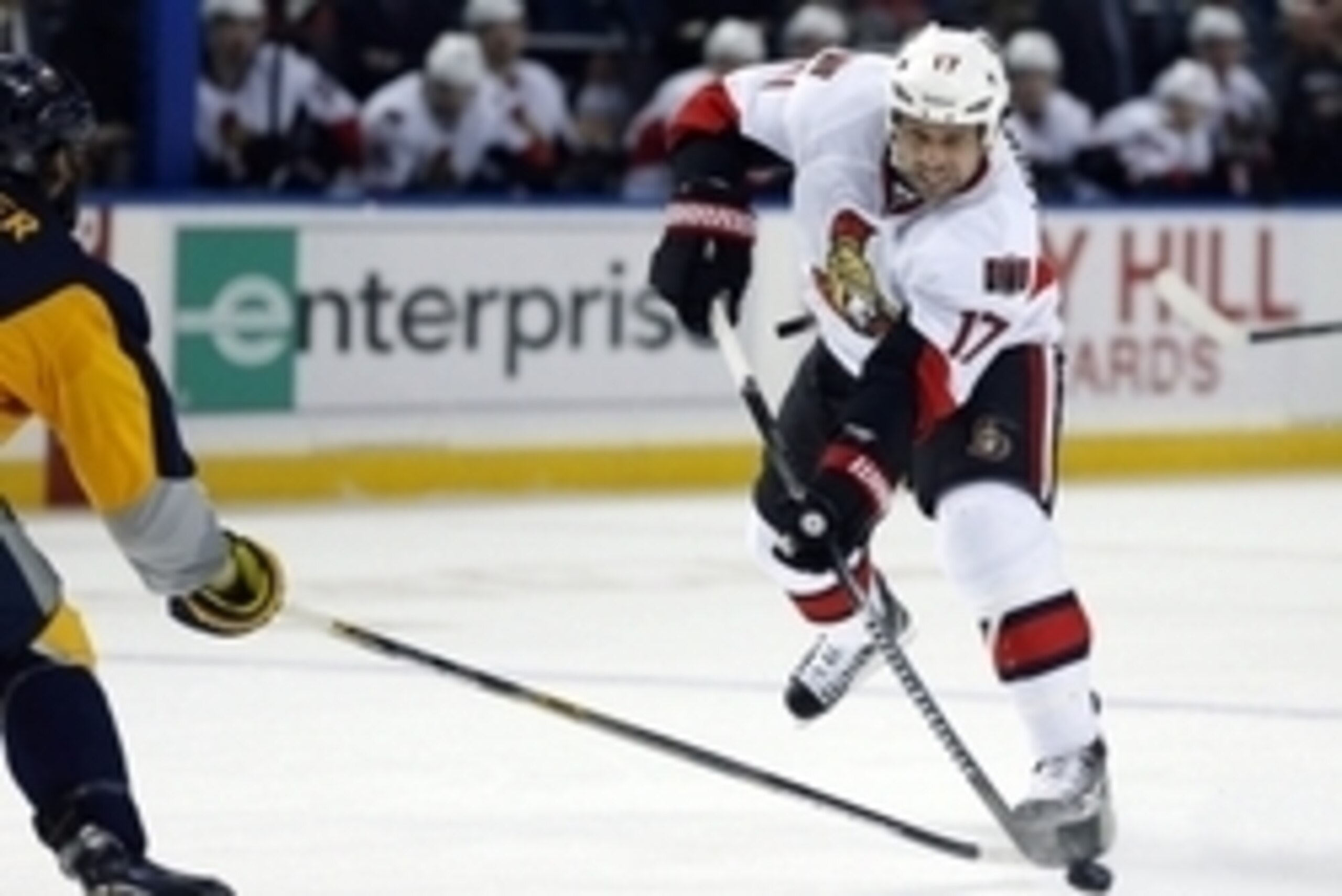 Feb 10, 2015; Buffalo, NY, USA; Ottawa Senators center David Legwand (17) takes a shot as Buffalo Sabres defenseman Mike Weber (6) defends during the first period at First Niagara Center. Mandatory Credit: Kevin Hoffman-USA TODAY Sports