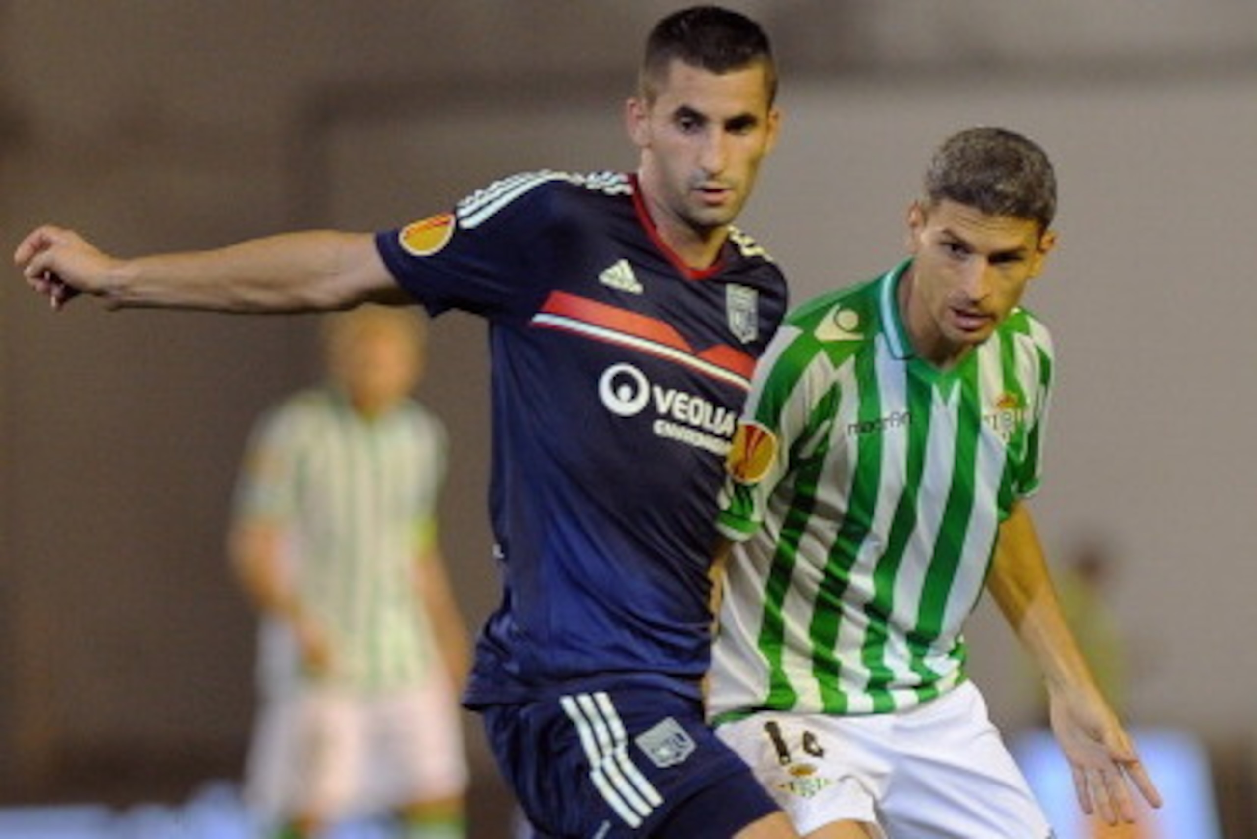 SEVILLE, SPAIN - SEPTEMBER 19: Maxime Gonalons (L) of Olympique Lyonnais challenges Salvador Sevilla of Real Betis Balompie during the UEFA Europa League group stage match between Real Betis Balompie and Olympique Lyonnais held on September 19, 2013 at t SEVILLE, SPAIN - SEPTEMBER 19: Maxime Gonalons (L) of Olympique Lyonnais challenges Salvador Sevilla of Real Betis Balompie during the UEFA Europa League group stage match between Real Betis Balompie and Olympique Lyonnais held on September 19, 2013 at t