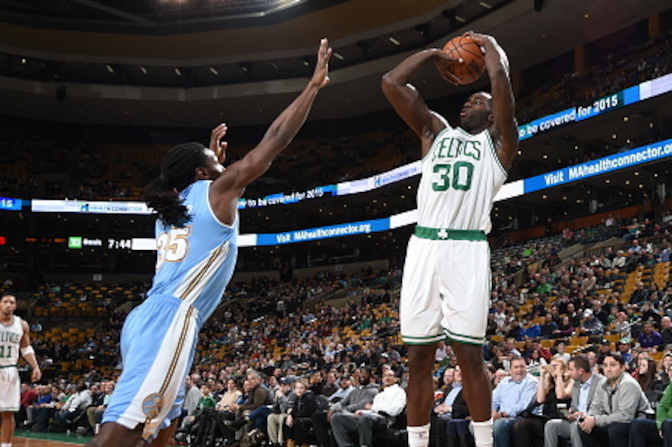 BOSTON, MA - FEBRUARY 4:  Brandon Bass #30 of the Boston Celtics shoots against Kenneth Faried #35 of the Denver Nuggets on February 4, 2015 at TD Garden in Boston, Massachusetts.  NOTE TO USER: User expressly acknowledges and agrees that, by downloading 