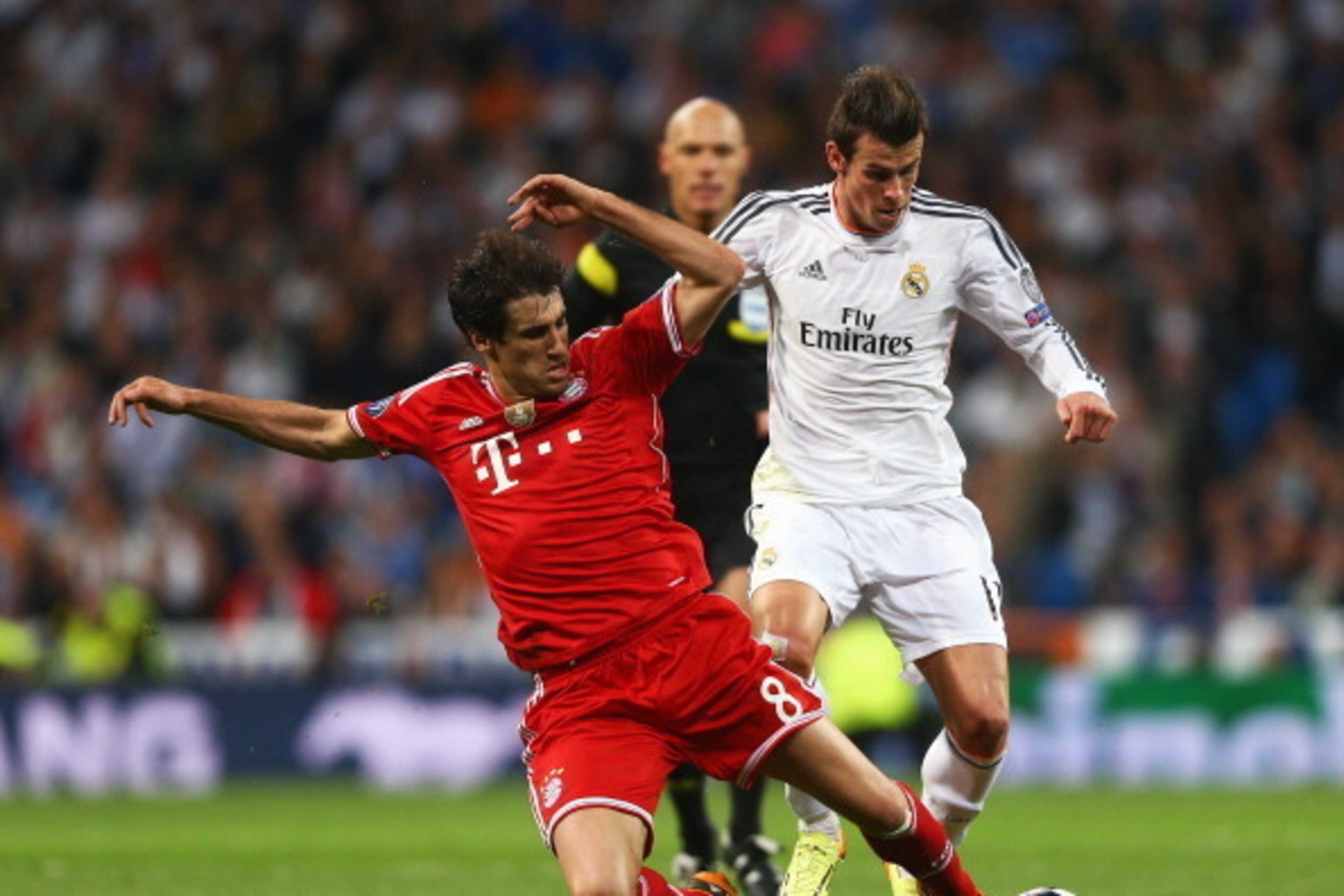 MADRID, SPAIN - APRIL 23: Gareth Bale of Real Madrid takes on Javi Martinez of Bayern Muenchen during the UEFA Champions League semi-final first leg match between Real Madrid and FC Bayern Muenchen at the Estadio Santiago Bernabeu on April 23, 2014 in Ma MADRID, SPAIN - APRIL 23: Gareth Bale of Real Madrid takes on Javi Martinez of Bayern Muenchen during the UEFA Champions League semi-final first leg match between Real Madrid and FC Bayern Muenchen at the Estadio Santiago Bernabeu on April 23, 2014 in Ma