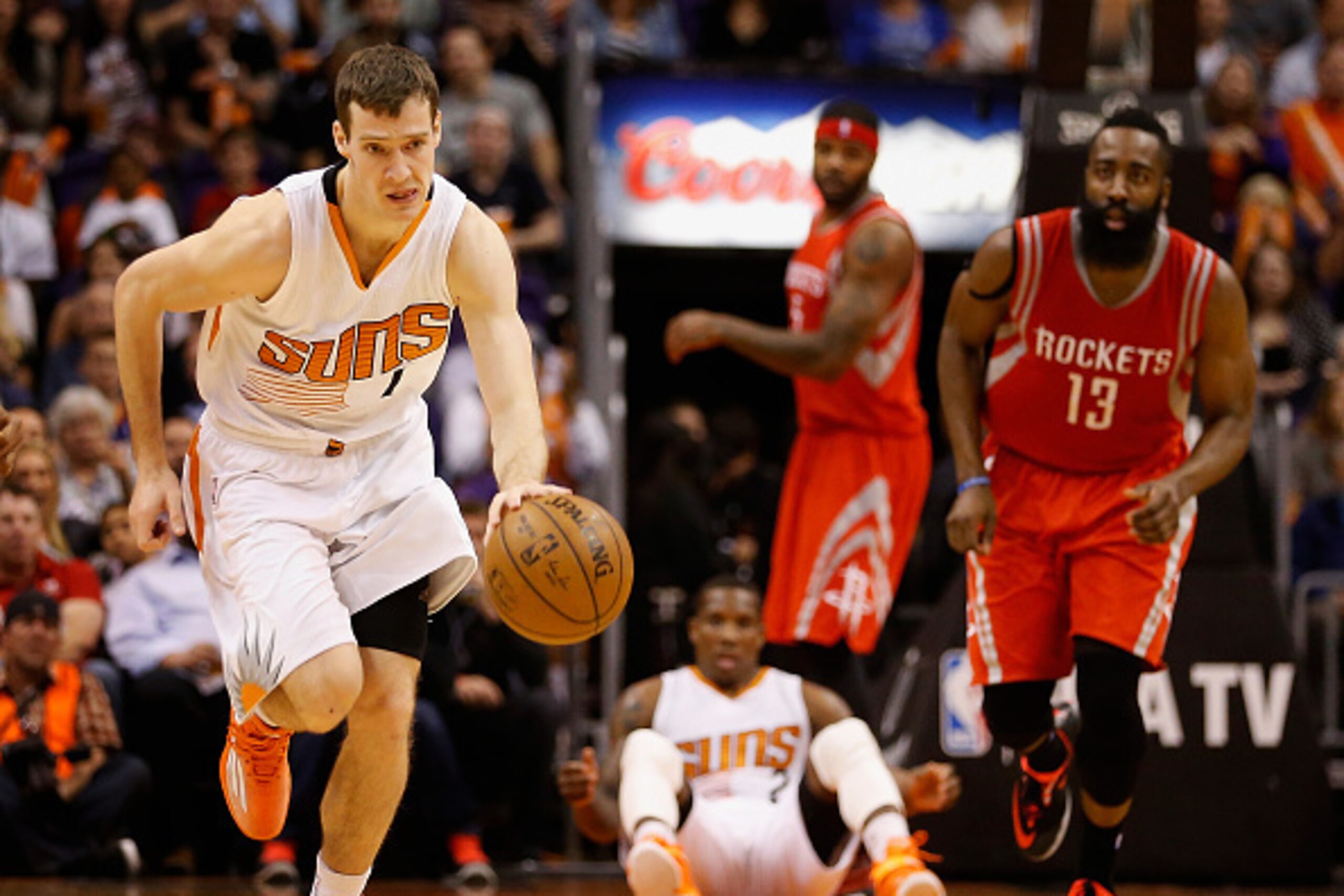 PHOENIX, AZ - FEBRUARY 10:  Goran Dragic #1 of the Phoenix Suns moves the ball upcourt after a turnover from James Harden #13 of the Houston Rockets during the second half of the NBA game at US Airways Center on February 10, 2015 in Phoenix, Arizona. The 