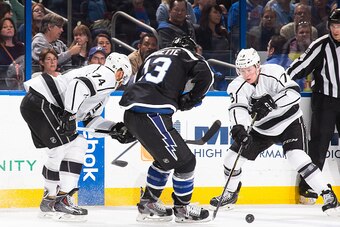 TAMPA, FL - FEBRUARY 7: Cedric Paquette #13 of the Tampa Bay Lightning battles for the puck against Dwight King #74 and Tyler Toffoli #73 of the Los Angeles Kings during the second period at the Amalie Arena on February 7, 2015 in Tampa, Florida.  (Photo 