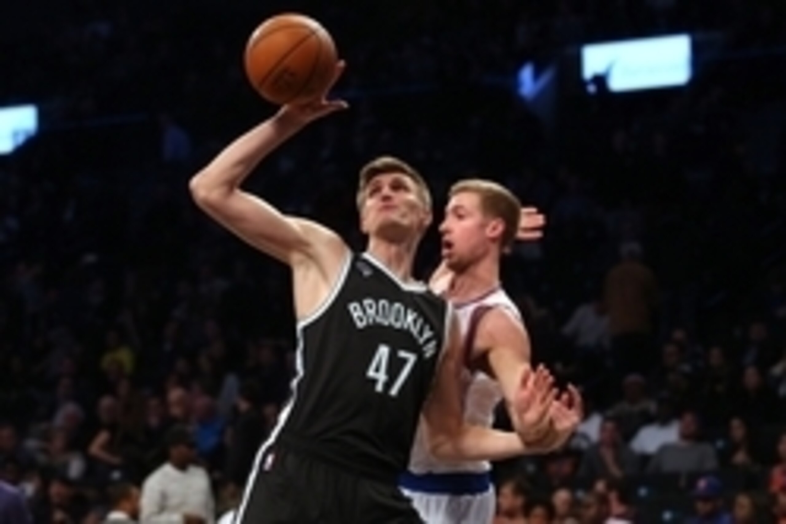 Nov 7, 2014; Brooklyn, NY, USA; Brooklyn Nets small forward Andrei Kirilenko (47) grabs a rebound in front of New York Knicks small forward Travis Wear (6) during the fourth quarter at Barclays Center. The Nets defeated the Knicks 110-99. Mandatory Credit