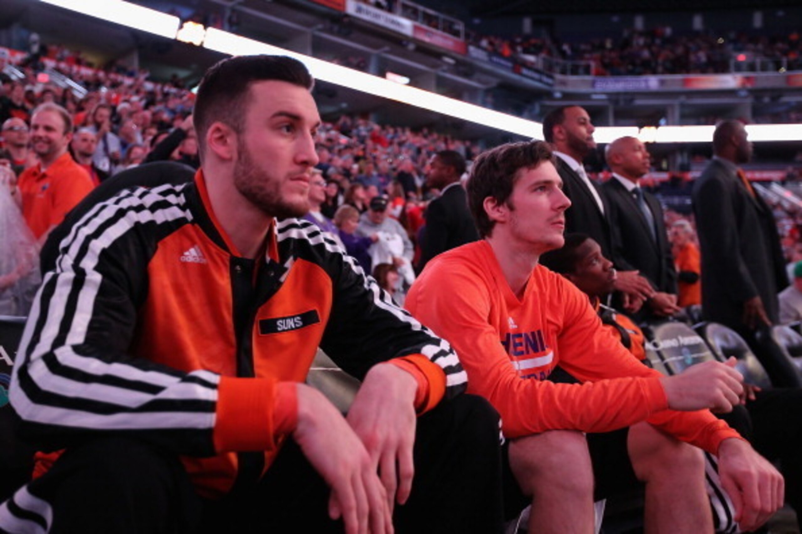 PHOENIX, AZ - DECEMBER 21:  Goran Dragic #1 (R) and Miles Plumlee #22 of the Phoenix Suns sit on the bench during intoductions to the NBA game against the Dallas Mavericks at US Airways Center on December 21, 2013 in Phoenix, Arizona.  The Suns defeated t