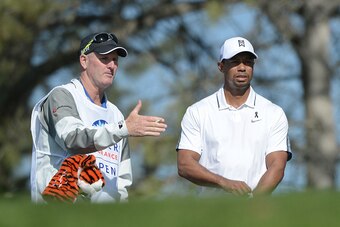 LA JOLLA, CA - FEBRUARY 05:  Tiger Woods (R) prepares to play his tee shot on the 17th hole of the north course during the first round of the Farmers Insurance Open at Torrey Pines Golf Course on February 5, 2015 in La Jolla, California.  (Photo by Donald