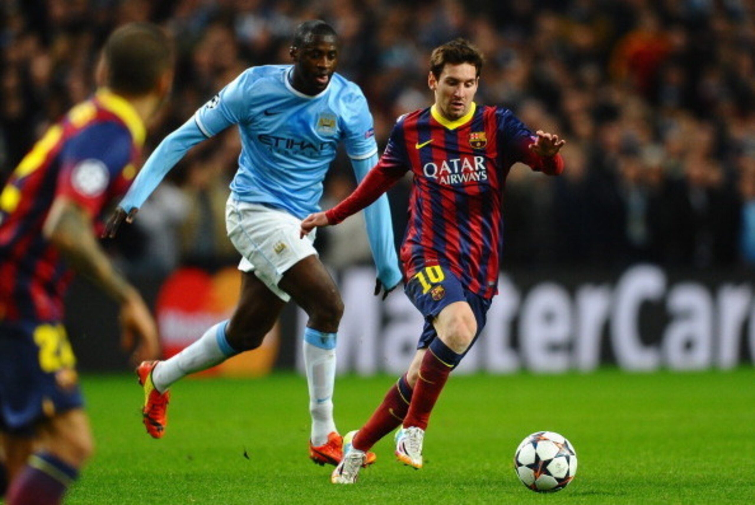 MANCHESTER, ENGLAND - FEBRUARY 18: Lionel Messi of Barcelona competes with Yaya Toure of Manchester City during the UEFA Champions League Round of 16 first leg match between Manchester City and Barcelona at the Etihad Stadium on February 18, 2014 in Manc MANCHESTER, ENGLAND - FEBRUARY 18: Lionel Messi of Barcelona competes with Yaya Toure of Manchester City during the UEFA Champions League Round of 16 first leg match between Manchester City and Barcelona at the Etihad Stadium on February 18, 2014 in Manc